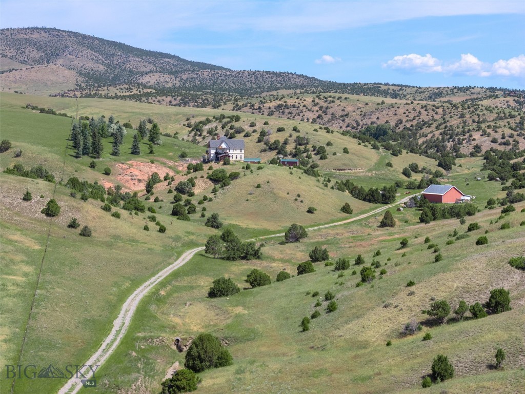 Set on 140± acres of open rangeland northwest of Belgrade, Hidden Spring Hills offers a rare chance to own a vast and unspoiled piece of the Gallatin Valley—an increasingly scarce opportunity in a region undergoing rapid development. This land is the main event: wide horizons, unobstructed mountain views, and a quiet that speaks to what Montana once was. Minimal covenants. No HOA. No commercial encroachment. Just space, sky, and possibility.
Beautiful rolling acreage with water rights (a 350 gpm irrigation well stands ready for a future owner to put water to work) and southern exposures offers pasture land for horses and livestock as well as space for all of your recreational needs– horseback riding through sunlit meadows, hiking hidden trails, sledding down snow-covered hills, cross-country skiing, or quietly observing the rhythm of wildlife in every season. Develop your own trails or follow the game trails that take you past distinctive rock outcrops, a small hidden natural spring, ravines and meadows sheltering wildlife, birds, flowers, and native grasses. 
At the heart of the parcel stands the historic Quaw Mansion– a Queen Anne landmark built in 1892 and relocated here decades ago as part of a preservation effort. The structure has been stripped to the studs and has roughed in plumbing and electrical. Its architectural bones and period details remain, waiting for a future owner to restore its legacy or reimagine its footprint. A fully finished walk-out basement provides comfortable living quarters while plans for the upper levels take shape. A detached 40'×40' shop adds valuable space for equipment, toys, or staging a renovation.
Indulge in blue-ribbon fishing on the East Gallatin River, just three minutes away, or plan an adventure into the nearby Gallatin National Forest, offering big game hunting and camping. From the homesite, take in spectacular views overlooking the East Gallatin and the rural farms and ranches that sweep outward to meet the majesty of five surrounding mountain ranges.
With its scale, privacy, water, wildlife, and storied past, this property is ideal for someone seeking solitude, long views, and a tangible connection to the valley’s heritage—before the subdivisions, before the traffic, before the sprawl. Whether preserved, rebuilt, or redefined, the land speaks for itself.