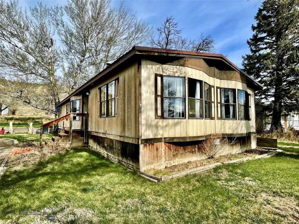 Cozy up to the pellet stove in this inviting 3 bed, 2 bath Fort Benton home. Surrounded by greenery and set on a generous lot, this property offers space to relax and room to make it your own. Whether you're considering a rental, starter home, or a laid-back retreat, the potential here is easy to see. Practical, affordable, and located in the quiet, historic town of Fort Benton, you’ll also enjoy nearby access to the Missouri River—perfect for fishing, floating, and soaking!