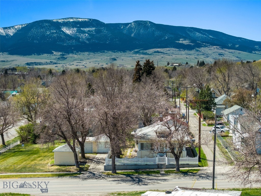 Ever dreamed of owning a charming historic home with the quintessential “white picket” fence, a view of the Absaroka Mountains and located in the highly sought after town of Livingston, MT?  This warm and inviting, CIRCA 1923 2 bedroom, 1 bath home has preserved its original character allowing a sense of history and personality increasingly hard to find.  Original woodwork, doors, trim, built-in cupboards, vintage light fixtures and a cozy front porch.  The full basement offers excellent potential for future finished living space.  Situated on a 10,500 sq ft corner lot with a detached 2 car garage and an additional storage shed that all blend with the home’s exterior offering strong curb appeal.  This home has been well loved and is ready to welcome its new owners.  Two adjoining lots with a garage are also available for purchase (see MLS#407572), offering a rare opportunity for added space or investment.  The property was recently taken off of the market while the Seller had the basement professionally repaired.  Call Listing Agent for details about the repair.  Schedule your showing 
today as opportunities like this don’t come along often!
