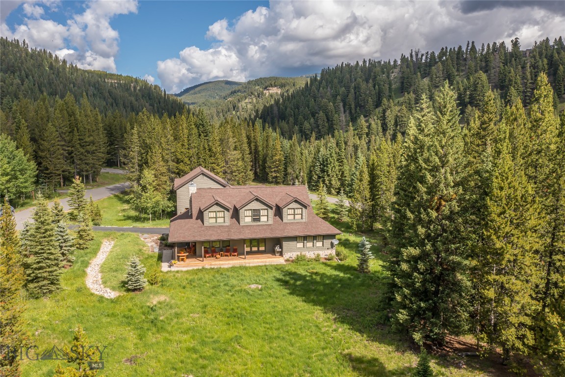 Unique and stunning, this true Montana home offers designer finishes throughout, which include hewn white oak flooring, custom doors with upscale hardware, fully remodeled bathrooms including an ADA accessible main floor ensuite, and an additional dwelling unit (ADU) above the garages. 
 
The main house offers 3 bedrooms, including a main floor primary bedroom, as well as 3 ensuite bathrooms and a powder room.  The upstairs primary bedroom features 2 walk in closets, a reading nook, soaking tub and a coffee station.

High-speed internet, 2 dishwashers, Murano glass fixtures, full-sized laundry, and a custom designed pantry are additional features of this beautiful residence.  There is also a natural stone wood-burning fireplace in the open concept kitchen/living/dining space.

Above the garages is a spacious 2 bedroom apartment, with a 3/4 bath and kitchenette, perfect for guests, in-laws or older children.  This unit also has hardwood flooring throughout, roomy closets and is tastefully appointed.

There are 4 heated garage bays, with a warm ski storage room and additional storage capacity in the attic – plenty of space for vehicles, toys and tools.  One of the 2 bay garages has a pull through back driveway for easy pullouts.

The landscaping includes abundant old growth lodgepole pines and spruce trees, aspen trees, flowering bushes and native grasses.  The slate paver walkway leading from the rear private deck (with a new hot tub) leads to a shaded patio, perfect for lounging in a hammock.

Nestled in the coveted Aspen Grove neighborhood, with city water and sewer, there is abundant wildlife moving through the area on their way to the Middle Fork of the Gallatin River, just below the bordering road of Autumn Trail.  Frequently seen visitors are moose, elk, fox, coyotes, deer, heron and bear.  The neighborhood also boasts cross-country and hiking trails for outdoor recreation year round.

Note:  Adjacent to this exclusive property is an additional 1 acre lot to the east that can be purchased separately.  Please inquire with the listing agent for more details on this additional acreage.

Due to new tax law, Buyer's property taxes in 2026 and beyond may differ significantly from prior years. Tax classification will be based on Buyer's use. Primary homes and investment properties with long term tenants will have the more favorable tax rates.