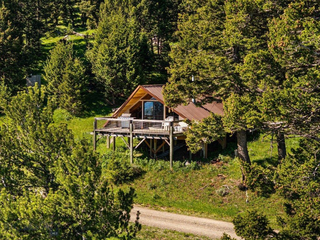 Escape the noise at this lovely, turnkey A-frame cabin tucked away in the woods halfway between Bozeman and Livingston. Offering total peace and privacy, this one-room retreat delivers the ultimate Montana lifestyle. Efficient one-room layout complete with a kitchen, dining area, living space, bathroom, and room for two beds. Panoramic vistas of mountain meadows, mature trees, and the iconic Crazy Mountains. A hunter’s dream! Enjoy private, owner-only easement access to thousands of acres of adjacent Forest Service land. Highly successful seasonal vacation rental history. Zero light pollution means unparalleled stargazing. Includes power, strong cell service, a well, and an oversized septic system already sized for future bedroom expansions.