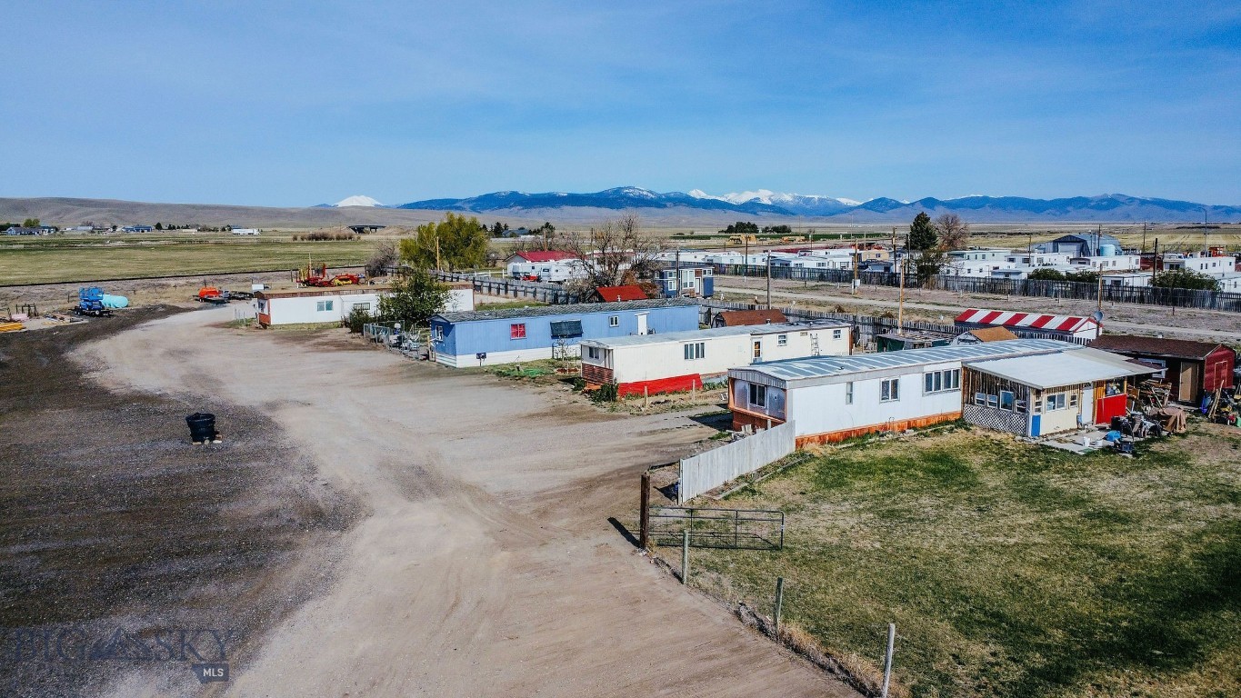 Discover an established investment opportunity set on two 2+/- acres minutes from town in Southwest Montana. The property includes one fully owned manufactured home and three currently rented manufactured home lots, two wells and septic units with room for additional building. Partial fencing and plenty of parking creates nice privacy and convenience for tenants. A blank slate that is awaiting your execution of wonderful ideas.  This provides both flexibility and the chance to grow your portfolio in a gorgeous setting.
