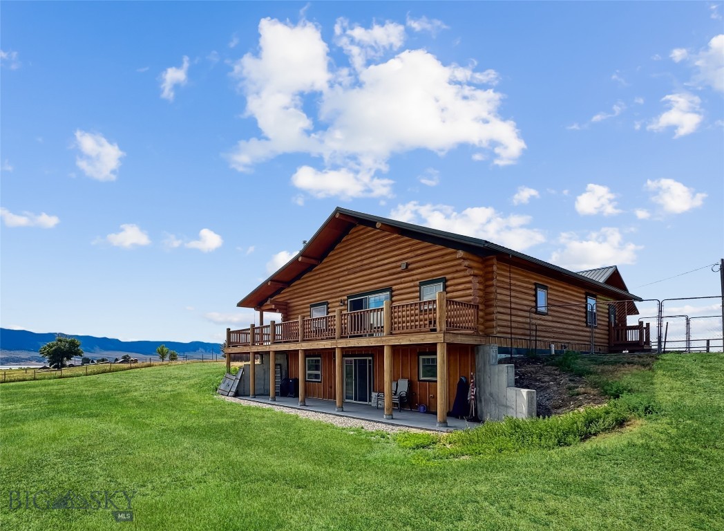 NO COVENANTS on this 3+ acres (Seller is doing a lot line adjustment - 3.14 acres is proposed) which is adorned by a beautiful-traditional log home, historic barn, and multiple outbuildings all located just minutes from Ennis Lake. This complex is bordered by larger ranch lands on two sides giving privacy as well as unobstructed views of the Madison and Tobacco Root Mountains. Enjoy your morning coffee on the wrap around, partially covered deck, as you listen to the Sandhill Cranes and watch the moose saunter by South Meadow Creek (on the ranch property to the north). The house has two full living units - one on the main floor and one in the daylighted walk out basement - making it ideal for VRBO, multiple families, potential care-taker, or rental income as both have full gourmet Chef's kitchens (convection-air fryer ovens, induction burners, preparation area with salad sink and more), large open floor plans, multiple bedrooms (ensuite + 1 on main floor and 2 down with egress windows) & multiple baths. The main floor centers around a wood fireplace, has white oak wood flooring, 4" sawed log breakfast bar with built in 1930's retro stools, knotty hickory cabinets with crown molding, formal entry, dedicated laundry room, and more. The basement continues the attention to detail with quartz counter tops, wood doors & trim, and another log breakfast bar. The entire house is heated by radiant heat (8 zones which includes the zone that heats the attached 30' x 30' garage) and has a reverse osmosis water system. Add incredible views of the Madison & Tobacco Root mountains (as well as a view of Ennis Lake) and easy access to and from Bozeman's airport. The property is priced to SELL so do not delay setting up a showing today!