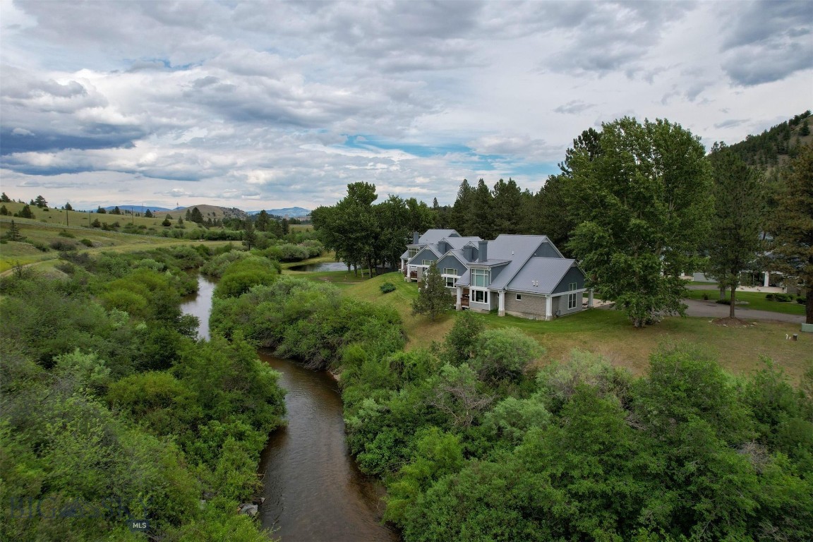 This creekside end unit backs directly onto Prickly Pear Creek, offering extra privacy, peaceful water views, and direct access from your back patio—one of the most sought-after locations in the community. Less than 10 minutes from Helena and located in the welcoming town of Montana City, this new construction condo sits in a 55+ community where nature and convenience meet. The 1,752 sqft layout offers main-floor living with 2 bedrooms, 2.5 bathrooms, quartz countertops, and a smart, open floor plan. Wide hallways, grab bars, and a zero-entry shower in the primary suite make it accessible and easy to navigate. Built with your health in mind, the home includes a whole-house water filtration system and a heat recovery ventilator that helps remove allergens like pollen and smog. Outside, explore private walking trails, relax by the pond, follow the banks of Prickly Pear Creek, or catch up with neighbors at the clubhouse. Thoughtful covenants help maintain the peaceful setting, and you can even tailor the finishes to match your style. Schedule a showing today!
Home is currently under construction - all interior photos are of the Model Home, not of this unit. Final Colors/Finishes/Upgrades may vary.