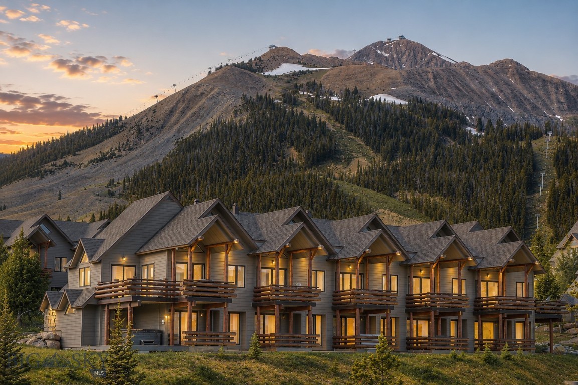 Located in the heart of Moonlight Basin, the Saddle Ridge Townhomes open to the Spanish Peaks, with views held from first light to last. Morning light crosses the range, Lone Mountain rises to the west, and the view carries through every room. It is one of the reasons to be here, and it does not change.
This slopeside retreat is a short walk from the Moonlight Lodge and steps from ski access at the Iron Horse and Pony lifts. From there the mountain opens onto the world-class skiing at Big Sky Resort and its 5,850 skiable acres. Come summer, the hiking and biking trails run in every direction. As Big Sky comes into its own, its shops, dining, and mountain culture grow more present by the season, from the Town Center to the One&Only Moonlight Basin, Montage Big Sky, and Big Sky Resort.
Beyond Moonlight, Bozeman lies an hour north, with Bozeman Yellowstone International Airport just past it. South, the road runs to Yellowstone National Park. West, the Madison Valley opens to blue-ribbon trout water on the Madison River, while the Gallatin runs the canyon the whole way in, with easy access for fly fishing and white water rafting. Farther out are the hot springs of southwest Montana, a greater range of trails, and the ski hills and historic towns that fill this part of the state.
Inside, the main level gathers around a gas fireplace beneath vaulted ceilings, with glass turned toward the alpenglow on the Spanish Peaks. The kitchen and dining area sit at the center of the day, ready for entertaining and quieter gatherings alike. Three bedrooms are arranged across two levels, a seclusion that lets everyone reset after days spent outside. A deck off the living space and a hot tub on the lower patio offer easy ways to unwind with family and friends.
Ownership here stands on its own. For those who want more, membership in the Moonlight Club is available, opening The Reserve — the Jack Nicklaus Signature course — along with outfitter activities, kids