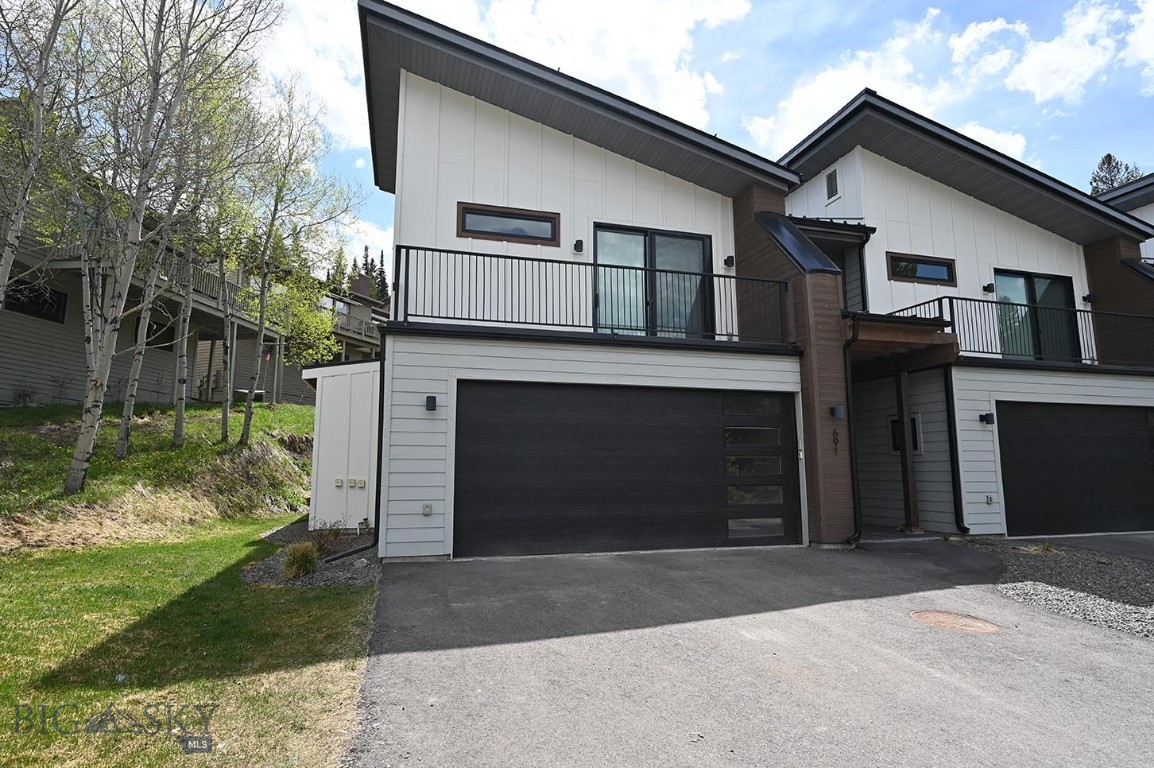 Fantastic end unit Sunburst condo in the Hidden Village area in the heart of Big Sky.  Just minutes from both the meadow and the mountain villages, this spectacular location offers both convenience and privacy.  Built in 2020, this unit is in like new condition and features a spacious floorplan with over 2,300 sq ft.  Enjoy the open concept living, kitchen dining area with propane fireplace, quartz counters and Bertazzoni appliances.  The spacious layout has plenty of space for entertaining while also feeling cozy.  Two sliding doors open up to the backyard and side patio and there is a half bath and heated two car garage on the main level.  Upstairs you'll find a large primary suite with a spacious private deck and spa bath with tiled shower.  There are two additional bedrooms, another nicely finished bath, laundry room and office. Unit is being sold "turn key" and is decorated and furnished very nicely and these properties have a great rental history.   Don't miss this spectacular unit in a desirable mid-mountain location close to all that Big Sky offers in the meadow and on the mountain!