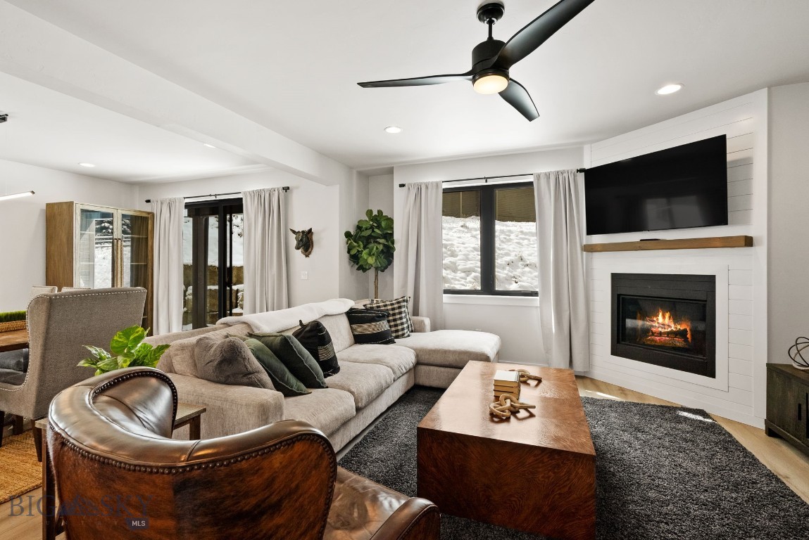 Fantastic end unit Sunburst condo in the Hidden Village area in the heart of Big Sky.  Just minutes from both the meadow and the mountain villages, this spectacular location offers both convenience and privacy.  Built in 2020, this unit is in like new condition and features a spacious floorplan with over 2,300 sq ft.  Enjoy the open concept living, kitchen dining area with propane fireplace, quartz counters and Bertazzoni appliances.  The spacious layout has plenty of space for entertaining while also feeling cozy.  Two sliding doors open up to the backyard and side patio and there is a half bath and heated two car garage on the main level.  Upstairs you'll find a large primary suite with a spacious private deck and spa bath with tiled shower.  There are two additional bedrooms, another nicely finished bath, laundry room and office. Unit is being sold "turn key" and is decorated and furnished very nicely and these properties have a great rental history.   Don't miss this spectacular unit in a desirable mid-mountain location close to all that Big Sky offers in the meadow and on the mountain!