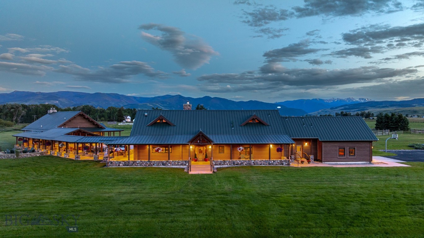 The legacy of the West comes alive at A River’s Ranch. Spanning over 55 usable acres across both banks of the West Gallatin River, this is a once-in-a-generation Montana ranch—minutes from Bozeman, Yellowstone, and Big Sky, yet a world entirely its own. From the Spanish Peaks to the Bridger Mountains, the views are cinematic and the land limitless. At its heart stands the main estate—a custom five-bedroom, five-bath log home built with the craftsmanship and permanence this landscape demands. Designed for generations, this 6,612-square-foot retreat is as enduring as the river that runs through the property itself. Anchored by a soaring great room with a floor-to-ceiling river rock fireplace and windows overlooking the pastures, the home is warm, generous, and built for earned comfort. Golden hand-hewn logs set the tone throughout while wrought iron fixtures and granite countertops speak to craftsmanship and intention. The floor plan flows naturally into the open chef’s kitchen and dining area, a space designed for living, gathering, and staying a little longer than planned. Additionally for guests, a private one-bedroom, one-bath guest house offers a complete and comfortable retreat. Close enough for connection, separate enough for privacy. The entertainment center is a destination unto itself—centered on a welcoming fireplace and fully equipped with a bar, kitchenette, pool table, dual television spaces, and a dining table built for a crowd. Outside, the property is equally equipped. An outdoor kitchen with a built-in smoker, multiple dining tables, and two generous fire pits create an al fresco entertaining space scaled for large gatherings and evenings that run long into the starlit night. For the horse enthusiast, the property is fully equipped and thoughtfully designed, with 21 horse bays, three fenced pastures with water access, a dry lot, and three round pens. A level riding area sets the stage for private training, rodeos, or recreational polo beneath an open Montana sky. On the water, a beautiful stretch of private West Gallatin River frontage delivers direct access to some of the finest blue-ribbon trout fishing in the region—no crowds, no competition, just the river and the rise. And to house everything this outdoor life demands, there is a substantial garage equipped for storage of gear and vehicles. A River's Ranch sits at the center of one of Montana's most enviable lifestyles.