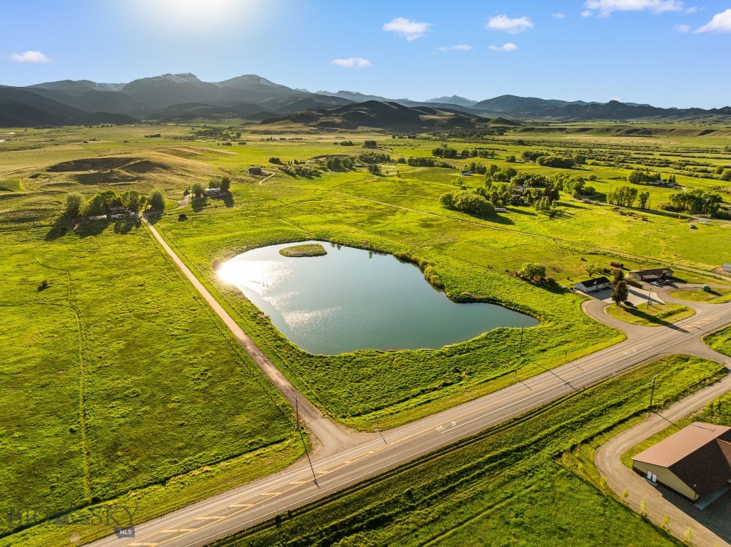 The Hebel Ranch spans 56± acres in the heart of the Madison Valley near McAllister, Montana, with commanding views of Ennis Lake and the surrounding mountain ranges. Located seven miles north of Ennis and 47 miles from Bozeman Yellowstone International Airport, the property offers strong access while maintaining the character of a picturesque Montana property! 

The land is perimeter and cross fenced and currently configured for equestrian and agricultural use, including two separate horse pastures with shelters. A spring fed 5± acre pond, supported by adjudicated water rights, serves as both a recreational feature and a functional asset, with an integrated fire suppression system hookup in place. Additional improvements include a permitted gravel pit and more than 900 feet of highway frontage, providing ease of access and long term utility.

Improvements include a 2,800± square foot, three bedroom, three bathroom manufactured caretaker’s residence accompanied by a large shop. The existing home offers comfortable living quarters while a future primary residence could be positioned on the upper portion of the ranch to take full advantage of the lake and mountain views.

With no known zoning, covenants, or restrictions, the property presents substantial flexibility for agricultural, equestrian, recreational, or commercial applications. The combination of water, access, infrastructure, and location within the Madison Valley positions Hebel Ranch as a highly adaptable land investment with both lifestyle and income potential.