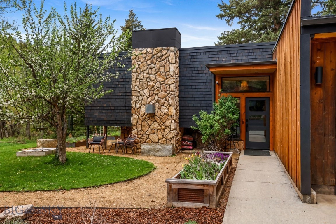 Set against protected public land with a creek running through the property, this thoughtfully reimagined mountain retreat features both a main house and a detached guest house—offering a rare blend of architecture, nature, and modern living just 12 minutes from downtown Bozeman. Meticulously transformed through an extensive renovation, the property has been reimagined into a fully realized retreat immersed in the Montana landscape. With a Warm modern interiors with subtle mid-century influences feature custom millwork, wide-plank wood flooring, layered natural materials, designer lighting, and refined architectural details throughout.
The exterior showcases cedar siding finished using the traditional Japanese Shou Sugi Ban technique, creating rich texture, durability, and a natural connection to the surrounding environment.
Expansive windows frame forest and creek views throughout the home, while the architectural layout creates seamless indoor-outdoor living. The custom kitchen serves as the heart of the home with bespoke cabinetry, integrated shelving, waterfall-style surfaces, and generous gathering spaces designed for everyday living and entertaining.
Additional highlights include a radiant-heated mudroom addition, integrated dry bar and built-ins, upgraded mechanical systems, and a insulated heated garage with upgraded flooring, storage systems, and workshop capability ideal for year-round mountain living.
Beyond the main residence, a fully renovated guesthouse offers a distinct architectural experience with corten steel siding, soaring ceilings, oversized windows, polished concrete floors, and a refined minimalist palette. The space offers exceptional flexibility for guest accommodations, multigenerational living, creative retreat use, or income potential.
Outside, private creek access, mature trees, direct adjacency to national forest, nearby hiking trails, and winter ski access from the property create an immersive four-season lifestyle—
Equally rare for the area, the property is unencumbered by covenants or HOA restrictions, offering exceptional flexibility for personal, recreational, or income-producing use.
Properties combining architectural identity, privacy, guest accommodations, recreation access, income potential, and proximity to town are increasingly difficult to find. This is more than a luxury home—it is a refined retreat where thoughtful design and the Montana landscape exist in seamless harmony.
