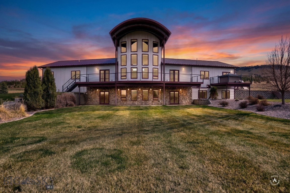 A beautiful and spacious retreat just minutes from town, this gorgeous 7,208 sq.ft. home features the prefect balance of comfort and luxury tucked away on just over 81 acres of privacy with views of the nearby mountains and vistas. With 5 bedrooms and 4 full bathrooms, there is ample space for friends and family, while the large primary suite with spa-like bathroom, private deck and hot tub allows the comfort and privacy to step away from it all. The home features two kitchens, one upstairs and one downstairs that is perfect for entertaining. The lower level also boasts a state-of-the-art media room complete with a new Sony theater system and surround sound, providing a fantastic space for movie nights or watching your favorite sports events. Did we mention there is also a sauna for your enjoyment on the cold winter nights? The hot water heat is powered by solar as well.  
The property boasts two large-heated shops that give plenty of versatile space for storage, hobbies and recreational vehicles. A 40X80 shop nearest to the house is equipped with cabinets, an air compressor, car hoist, and an additional basement room equipped with growing lamps. The larger 60X120 shop has plenty of room for recreational vehicles and equipment to fully enjoy Montana’s four seasons. The property also offers a greenhouse and garden space, ideal for gardening and self-sustainability. With ample acreage, luxurious amenities, and versatile spaces, 6131 Johnson Road provides a rare opportunity for those seeking a peaceful and spacious lifestyle close (but not too close!) to beautiful and picturesque Helena, Montana.