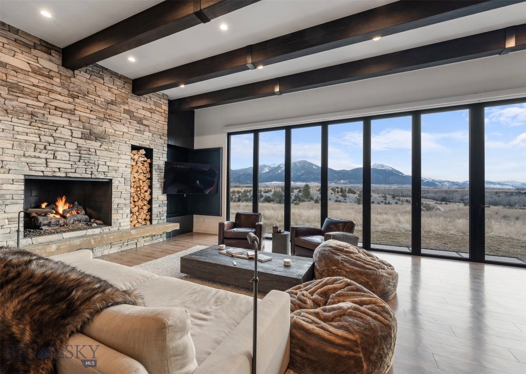 Rising above the valley floor in the heart of Paradise Valley, 31 Majestic Ridge Trail is a striking modern masterpiece where architecture, landscape, and design converge. Set against the dramatic backdrop of the Absaroka Mountains, this extraordinary residence captures panoramic views in every direction, creating a living experience that feels both expansive and intimately connected to Montana’s raw beauty.

Designed by Stone Alexander Design, the home is a study in rustic modernism. Custom Anderson windows and a dramatic glass pivot double-door entry set the tone, while a NanaWall sliding glass system dissolves the boundary between indoors and out, opening the great room to sweeping mountain air and endless skies.

Inside, industrial scale meets organic warmth. A soaring great room is anchored by a 50-inch fireplace and enhanced by wood walls, wood ceilings, and architectural beams that bring texture and depth to the contemporary aesthetic. An industrial-grade AC unit ensures year-round comfort, while in-floor radiant heat delivers subtle, luxurious warmth underfoot.

The kitchen is a sculptural showpiece, featuring custom cabinetry, panel-ready appliances, and elevated finishes throughout. Restoration Hardware lighting, cabinetry, sinks, and curated furnishings complement the clean lines and intentional material palette. Every detail reflects thoughtful craftsmanship and quiet luxury.

The primary suite is a private retreat, highlighted by a spa-level bath with statement wall and floor tile, refined fixtures, and serene design continuity. Wellness is woven into the home’s lifestyle appeal with a private sauna, hot tub, and dedicated in-home gym — creating a resort-level experience without leaving your property.

Exterior finishes include upgraded siding from Montana Timber Products, reinforcing both durability and architectural integrity. A full home security camera system provides peace of mind, allowing effortless lock-and-leave capability.

Located near Livingston, under an hour to Bozeman Int Airport and within easy reach of Yellowstone National Park, world-class fly fishing, hiking, skiing, and open-space adventure are at your doorstep. Yet from the privacy of Majestic Ridge, the soundtrack is wind through the valley and the shifting light across the peaks.

31 Majestic Ridge is not simply a home — it is a modern architectural retreat designed for those who seek elevated living in one of Montana’s most iconic landscapes.