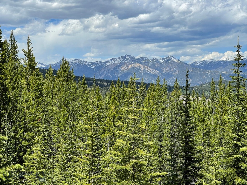 Own a piece of Montana with this premier 39.97-acre property, a rare gem in the heart of Big Sky. This expansive parcel directly borders the National Forest, providing a private gateway to pristine wilderness and unlimited reacreation. Imagine waking up to sweeping views of the Spanish Peaks before stepping directly onto the community cross-country skiing route that winds through the land. Whether chasing morning powder on a snowmobile, embarking on a premier hunt in the adjacent wilderness, or exploring high-alpine terrain via OHV and hiking trails, this acreage is an unmatched sanctuary for the outdoor enthusiast. 

Two potential build sites have been thoughtfully cleared and marked on the lower 20 acres to capture optimal mountain scenery. To protect the integrity of the land and local wildlife, the upper acreage remains a preserved natural corridor. Located within an exclusive gated community with HOA-maintained roads, this property provides the security of reliable, year-round access. This is a significant, multi-generational opportunity to own an exclusive parcel in the region with the prestige of Big Sky, MT living. 

This property is minutes away from the vibrant Big Sky community, the legendary slopes of Big Sky Resort, the local golf course, and the blue-ribbon fly fishing of the Gallatin River. 

Contact your favorite Realtor today for a private tour!