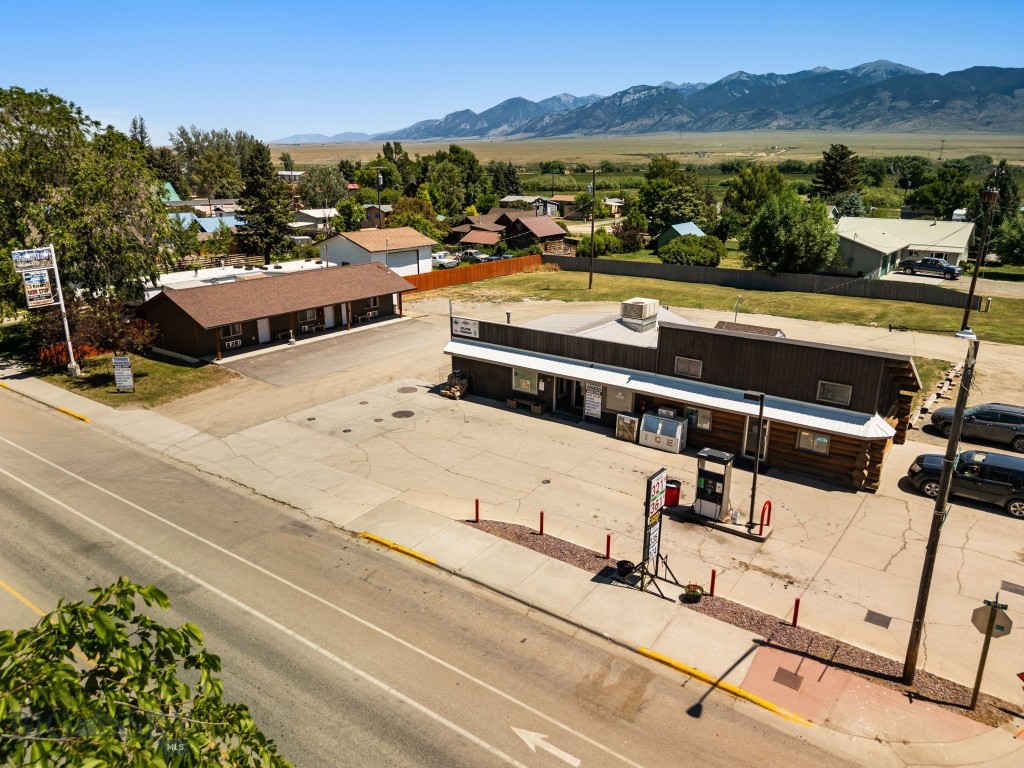 Exceptional commercial opportunity in the heart of Twin Bridges, MT. This well-established gas station, convenience store AND three apartments are deally located on 0.634± acres with prime frontage along Highway 287, offering excellent visibility and consistent traffic from both locals and travelers. The convenience store is fully stocked and includes a variety of essentials, fishing gear, and a commercial fryer with fire suppression system. A beer and wine license will be offered with the purchase of the business, subject to state transfer approval. In addition to the retail operation, the property includes three stylish, recently updated studio apartments, each offering modern comfort with a new kitchen, full bathroom, air conditioning, and a covered patio. A shared laundry room is available for tenant use. These units provide flexible options for rental income or workforce housing. Whether you're looking to operate a thriving business, invest in a multi-use property, or expand your portfolio, this versatile property offers immediate income potential and long-term value in a sought-after Montana community.