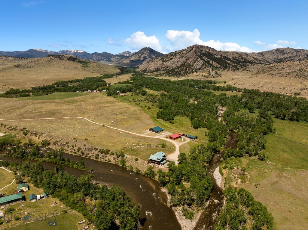 Where crystal-clear trout streams converge beneath the dramatic peaks of Montana’s Beartooth Mountains, Two Rivers Lodge presents an extraordinary opportunity to own one of the region’s most iconic riverfront properties. Situated on 12± acres at the confluence of the Stillwater River and the West Fork of the Stillwater, the estate offers an unmatched combination of world-class fly fishing, breathtaking scenery, and exceptional privacy. Renowned for healthy populations of brown, brook, rainbow, and native Yellowstone cutthroat trout, these blue-ribbon waters flow directly through a setting designed for recreation and relaxation. Located in the small community of Nye, Montana, just 25± miles from Absarokee and a little over an hour from Billings and its commercial airport, the property balances seclusion with convenient accessibility. Currently operating as Two Rivers Lodge and Events, the estate could continue as a successful hospitality venture or transition seamlessly into a private family compound or corporate retreat. Improvements include a 4,235-square-foot main lodge, two beautifully appointed guest cabins, and an event barn featuring a spacious one-bedroom, two-bathroom apartment with a full kitchen. Additional amenities include a storage barn, workshop, shed, greenhouse, and established garden area. Offered fully furnished and turn-key, Two Rivers Lodge is ready to be enjoyed from day one.