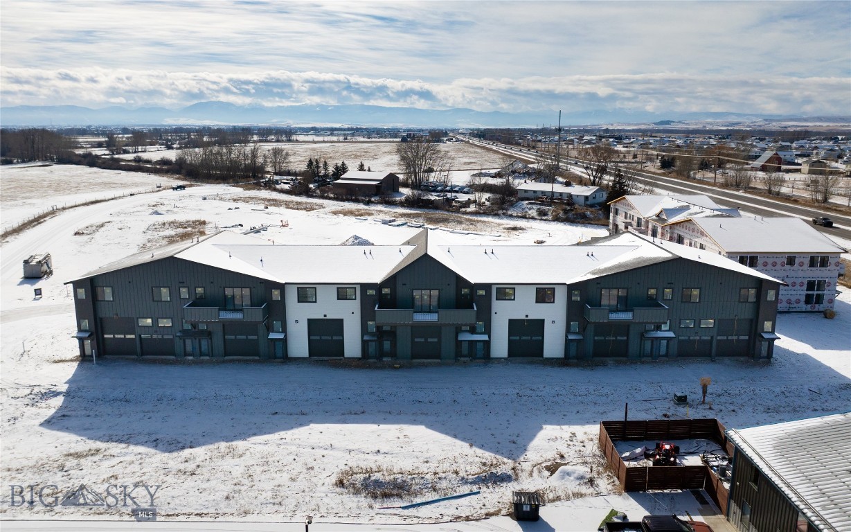 The Cottonwood Flex Plan at Fremont Square is designed for owners who want additional workspace without sacrificing flexibility upstairs. Offering approximately 2,671 square feet, the main level includes 1,286± SF of commercial space with 15-foot ceilings, a 12' x 14' overhead door - Pull through garage, and an ADA-compliant bathroom. The upper level provides 1,385± SF of flexible space that can function as an office suite, studio, or apartment with two bedrooms plus a open flex room that can serve as an office or separate living room. This plan features a large, south facing, 230 sq ft deck that spans the main bedroom and flex room. Located along Jackrabbit Lane near the new Jackrabbit Crossing development, Fremont Square delivers excellent visibility and access to I-90, Bozeman, Belgrade, and Big Sky. A perfect setup for trades, small businesses, hobbyist, owner operated businesses, or light industrial users seeking ownership with built-in versatility.