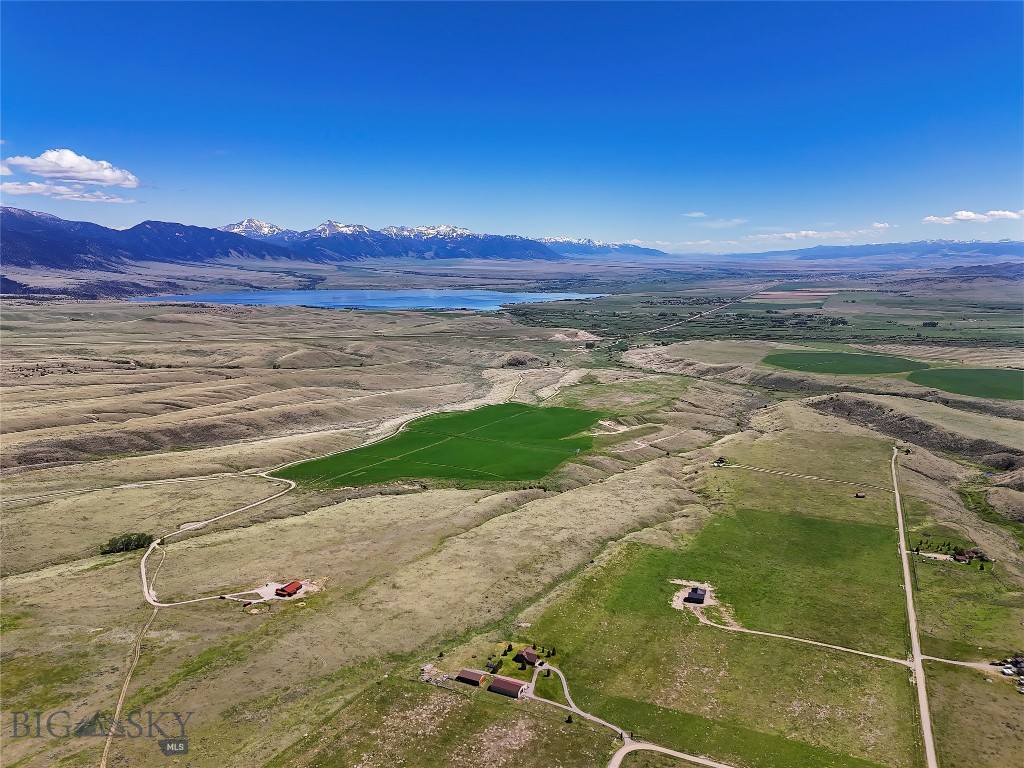 Exceptional 203.31± acre offering in McAllister, Montana, bordering State of Montana land at the far north end of the Madison Valley. This property combines irrigated hay ground, prime homesites, and panoramic views for a truly rare opportunity. Approximately 55± acres are under pivot irrigation with water rights, providing excellent hay production or grazing capacity. The balance of the land offers elevated building sites that encompass a variety of terrain and commanding 360° views of Ennis Lake, the Madison Range including Lone Peak, and the Tobacco Root Mountains. Five homesites are approved, each with incredible vistas of the valley and surrounding mountains.
Well-suited for a gentleman’s or horse ranch, the property offers agricultural utility and recreational opportunity. It borders state land and includes a walking easement to BLM, ensuring direct access to hundreds of acres of public land. Located less than an hour from Bozeman, this property combines privacy, productivity, and unmatched views in one legacy holding.