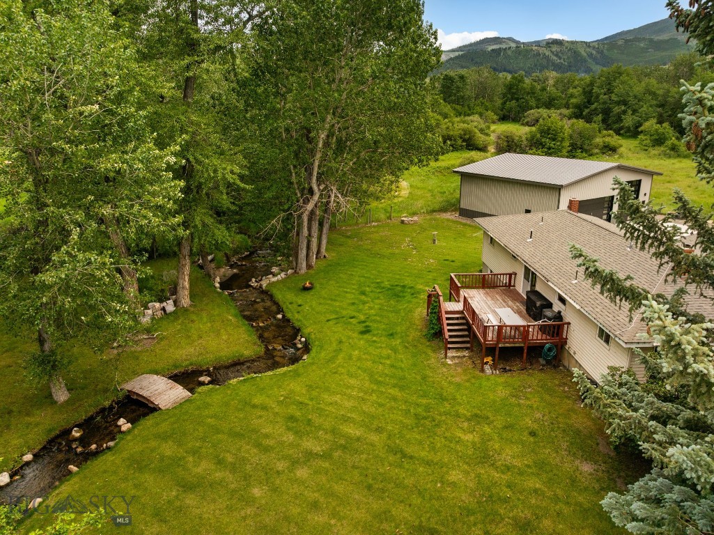 Perfectly positioned between Big Sky and Bozeman, this charming country property offers the best of Montana living with incredible mountain views, wide open spaces, and a peaceful rural setting. Situated on a quiet country road, the one-acre parcel enjoys a rare sense of privacy with no covenants or HOA restrictions. Wilson Creek meanders through the property, while the north and east boundaries adjoin 10 acres of designated park space, creating an expansive backdrop of open land and abundant wildlife.
The home has a very functional layout with three bedrooms and one bath on the main level, plus two additional non-egress bedrooms and a second bath in the full basement. Original hardwood floors add warmth and character, and the current owners have added a massive detached garage/shop, providing lots of space for vehicles, recreational gear, or a workshop. Whether you're looking for room to breathe, easy access to both Bozeman and Big Sky, or simply a place to enjoy Montana's stunning scenery and laid-back lifestyle, this property delivers.
