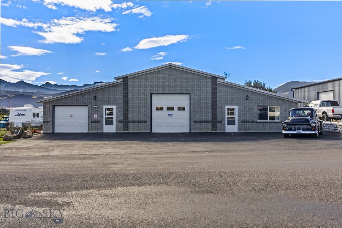 Set on three commercial lots totalling .75+/- acres just minutes from downtown Livingston, 1801 Sun Ave offers versatility and elbow room with a layout designed for living, working, and creating. This unique 3,456± sq ft structure combines a well-maintained main residence, an attached studio-style ADU with a private entrance, and a heated shop with a 12’ electric door and vehicle lift (negotiable)—ideal for car enthusiasts, woodworkers, or anyone needing space to build and store. Each living unit has its own garage, ensuring you won’t have to take up shop space for vehicle storage. The main home includes two spacious bedrooms—one on each end of the home with their own en suite bathrooms— tall ceilings, abundant natural light, and thoughtful updates including new landscaping with privacy fencing and freshly sealcoated paved parking, with plenty of room for your vehicles, toys, or business traffic. The attached ADU features its own entrance, a ¾ bath, and a flexible studio layout with laminate and carpet flooring. Highly insulated with zip panel and concrete construction, this property is energy efficient and built to last. Outside, the yard is fenced and includes raised garden beds, and room to expand. The property borders additional lots (included in the sale) that offer increased privacy and development potential. The East side of the property is edged by Fleshman Creek, and mature apple trees line the western boundary. With unobstructed views of the Absaroka Mountain Range, and space for projects, guests, or business expansion, this is a rare opportunity in Livingston for those who value function, freedom, and flexibility. Residential Listing: 406178, Home w/ Apartment Listing: 406294