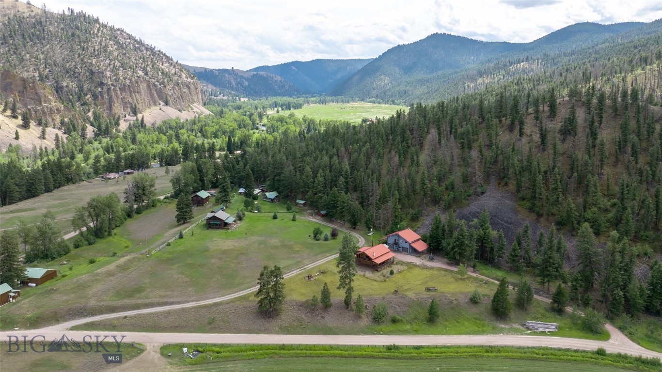 Tucked into the breathtaking Rock Creek corridor just outside of Philipsburg, this well maintained log home offers a rare opportunity to live where Montana’s legendary fly fishing and outdoor recreation are right at your doorstep. Set on 1.72 acres and bordered by Deer Lodge National Forest, the property boasts mountain views, including a striking view of Squaw Rock, and direct access to the wilderness. The 2,431 sq ft home features 2 bedrooms and 3 bathrooms across three spacious levels. The open concept main floor connects the living room, dining area, and kitchen, anchored by two cozy wood-burning stoves. Upstairs, the primary bedroom includes an en-suite bath and access to a private balcony overlooking the forested surroundings. The lower level offers additional living space, a second bedroom, and a full bathroom. Enjoy Montana’s seasons from the covered deck or tend to your plants in the attached greenhouse. An artesian well supplies the property with a reliable and consistent water source, while a large detached shop with two bay doors provides space for vehicle storage, projects, or gear. Located approximately 30 minutes from the historic town of Philipsburg, this property offers the perfect balance of seclusion, natural beauty, and access to small-town charm. Whether you're seeking a year-round residence or a recreational basec amp, this is a place where nature and comfort meet.