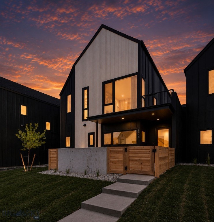 Experience the debut of the never-before-released Kul 5 floor plan in Gran Cielo—2,407 square feet of a thoughtfully designed Scandinavian-inspired condo blending modern architecture with warm, inviting finishes. Soaring ceilings and expansive Euro-style windows flood the hardwood-floored living room with natural light, while the striking wood-wrapped fireplace creates a stunning focal point. The open-concept layout includes a dedicated dining area with additional built-in cabinetry and a beautifully appointed kitchen designed for everyday living and entertaining. Upstairs, a spacious lofted family room offers flexible living space, while the private primary suite features a walk-in closet and spa-inspired bath with a curbless entry shower. With four bedrooms, three bathrooms, front and rear fenced patios, a second-level balcony, a fenced artificial turf yard, air conditioning, and an oversized two-car garage, this home offers exceptional comfort inside and out—all within Gran Cielo, one of Bozeman