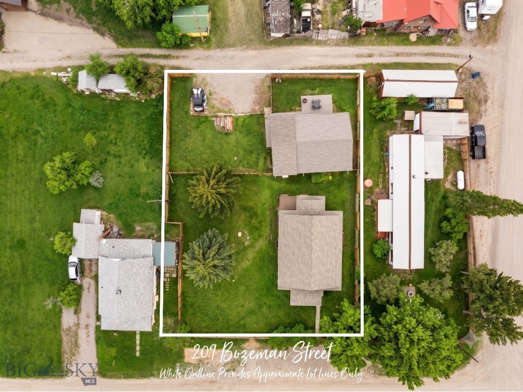 A 1915 bungalow with original hardwood floors, a covered front porch, and over a century of Montana character... paired with a modern guesthouse and a buildable lot, all on 1/3 acre in the heart of Gallatin Gateway. This is the kind of property people move here hoping to find.

The main home (~2,308 sq ft, 3 bed, 2 bath) has been thoughtfully updated while keeping the details that make a historic home worth owning: warm wood trim, period built-ins, and the kind of craftsmanship you simply can't replicate today. The main level features an updated kitchen with white cabinetry, a dining area that flows into the living room, two bedrooms, a full bath, and main-level laundry. The daylight lower level adds a third bedroom, second living area, and a beautifully finished ¾ bath with modern vanities, and it can be accessed from inside the home or through a private exterior stairwell, creating real flexibility for multigenerational living or guest accommodations.

The guesthouse (~1,008 sq ft, 2 bed, 2 bath) is a newer build with a bright, open kitchen, butcher block counters, a covered front patio, and a side yard deck. It's move-in ready as a rental, guest quarters, or home office with complete separation from the main residence.

Both homes sit two blocks from the Gallatin River. Fly fishing, rafting, hiking, and wildlife are part of daily life here, not a weekend trip. Stacey's Old Faithful Bar & Steakhouse and The Westerner (Montana's only real honky-tonk) are a short walk. Bozeman's restaurants, shopping, and airport are 20 minutes north. Big Sky's world-class skiing and mountain biking are 30 minutes south. You're not choosing between access and privacy... you're getting both.

No HOA. No covenants. No known zoning restrictions. The second lot in this double-lot parcel is unbuilt and ready for future development. Whether this becomes your family's home base, a retreat property, or an income-producing investment with short-term and long-term rental potential, the options are wide open.

Properties like this in Gallatin Gateway don't come up often. Call today for a private showing.