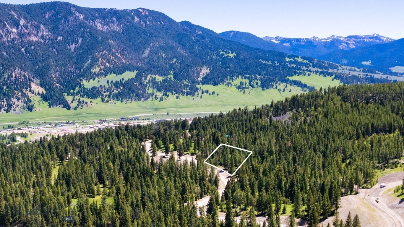 Gallatin Foothills Lot 30 is adjacent to the Terraflow biking and hiking trail and over 26 acres of open space and provides mazing views with mature trees. Its sloping lot is suitable for a walkout basement, offering both privacy and easy access to outdoor recreation.  Introducing the final phase of Gallatin Foothills, where residents will revel in spacious lots ranging from 1 to 2 acres, complemented by over 75 acres of dedicated open space. Each homesite, complete with mature trees and privacy, has been meticulously selected and designed to capture breathtaking sunrise and sunset views, alpenglow, and expansive mountain vistas, all while remaining conveniently close to town amenities. Neighborhood amenities include world-class Terra Flow mountain biking trails, sledding hills, and parks with open spaces perfect for hiking and cross-country skiing. At the base of the development, a trail network provides access to public lands, ideal for snowmobiling, ATV riding, and mountain biking. Fishing enthusiasts will appreciate the incredibly convenient 5-minute access to the Gallatin River. A short drive brings you to Big Sky’s Town Center, Big Sky Resort, and an even shorter trip to Ophir Elementary School, Lone Peak High School, the Warren Miller Performing Arts Center, and countless trailheads and recreational opportunities.