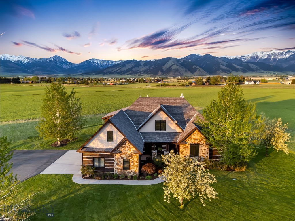 Celebrate Montana life in this timeless Montana home, where rustic elegance meets thoughtful functionality. Located on a private cul-de-sac, with breathtaking views of the Bridger range, the rural landscape is only minutes to Bozeman, the Yellowstone International airport, miles of recreational trails and Bridger Bowl ski area. The heart of the home is the chef's kitchen, featuring new granite countertops, premium appliances, farmhouse sink, a dining area and inviting sitting area-perfect for casual gatherings or quiet mornings. A stunning moss rock fireplace anchors the family room, creating a warm and welcoming space to enjoy the long winter months. New Montana hickory floors flow throughout much of the main level, adding a rich warmth. The spacious primary suite offers a luxurious escape with a jetted tub, rejuvenating steam shower and access to the back deck. The main level is complete with a designated office and fully appointed mother-in-law suite. Upstairs, two additional bedrooms share a Jack and Jill bath and are complemented by two versatile bonus areas-ideal for hobbies, play or relaxation. Enjoy seamless indoor-outdoor living with a covered patio, covered porch and sprawling deck, all designed to maximize the panoramic mountain views. Numerous updates include a new dishwasher, furnace, microwave, kitchen counters and floors. Exterior was recently stained. A heated garage ensures comfort throughout the seasons. This is Montana living at its finest-private, picturesque and perfectly​​‌​​​​‌​‌​​​​‌​​‌​​​​‌‌ appointed.