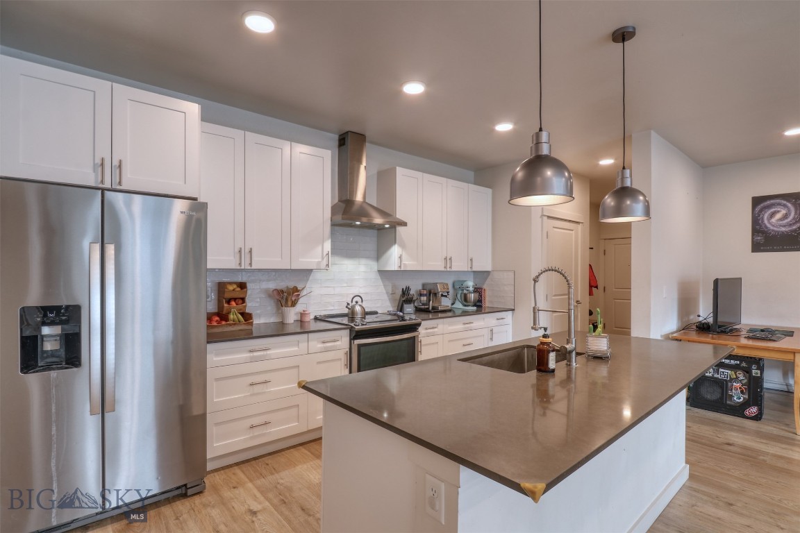 GREAT VIEWS! Ideally located in Livingston’s sought-after south side, The Flats at Yellowstone Bend offer a thoughtfully designed approach to modern in-fill living—just minutes from downtown, the Yellowstone River, walking trails, and convenient access to the I-90 corridor. Residents also enjoy access to a community clubhouse featuring meeting and event space along with a fitness gym, adding both convenience and lifestyle appeal. Unit 139 is a bright and spacious third-floor southwest corner residence featuring 2 bedrooms and 2 bathrooms. The open-concept living, dining, and kitchen area is filled with natural southern light, creating a warm and inviting atmosphere. The kitchen is both stylish and functional, complete with quartz countertops, shaker-style cabinetry, Whirlpool stainless steel appliances, and a dedicated pantry for added storage. Well-appointed finishes continue throughout with brushed nickel fixtures and durable laminate plank flooring. The primary suite offers a walk-in closet, and the overall layout provides comfort and livability in a low-maintenance setting. Step out onto the covered patio to take in mountain views and enjoy a peaceful outdoor retreat—an ideal extension of the living space for morning coffee or evening unwinding. Additional highlights include designated garage space (#49) and a private storage locker, perfect for seasonal gear and extra belongings. A great opportunity to own a modern, light-filled condo in one of Livingston’s most desirable locations.