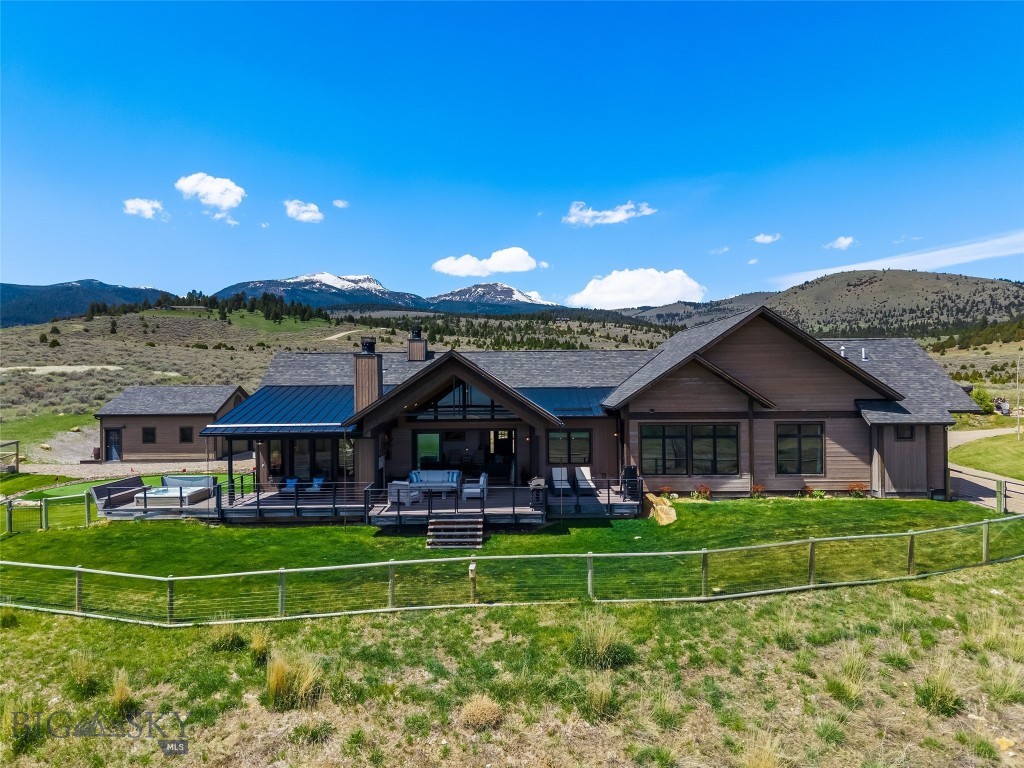 Welcome to an extraordinary Montana retreat in the highly sought after Stone Ridge Views at South Meadow Creek, where homes rarely become available. Built in 2020 by renowned builder John Benedict, this exceptional custom residence offers approximately 3,000 sq ft on 11.75 pristine acres overlooking Ennis Lake, the Madison Valley, and the breathtaking Madison Mountain Range with unobstructed panoramic views. This stunning 3-bedroom, 2.5-bath home also features a private office and inviting sunroom perfectly positioned to capture Montana’s spectacular scenery year-round. Rich Bora Oak hardwood plank floors, soaring wood ceilings in the great room, and a beautiful wood-burning fireplace create a warm atmosphere throughout the home. The chef’s kitchen features quartz countertops, an oversized island, abundant cabinetry with pull-outs, hidden pantry, and a Thor 6-burner gas range with griddle. Just off the attached heated two-car garage, the mudroom and laundry area showcase stunning antique brick flooring and exceptional functionality. The luxurious primary suite offers French doors to the expansive maintenance-free deck with sweeping mountain and lake views. The spa-inspired ensuite includes dual vanities, jetted soaking tub, private toilet room, oversized walk-in shower with multiple heads, and spacious walk-in closet. Two large guest bedrooms are connected by a bright Jack-and-Jill bathroom, while the office features striking antique French doors. Designed for comfort and efficiency, the home includes radiant in-floor heat, two on-demand water heaters, water softener, buried 1,000-gallon propane tank, mini split in the primary suite, and Generac generator. Outdoor living is equally impressive with landscaped grounds, underground sprinklers, 25 planted trees on drip system, fenced garden area with greenhouse, built-in firepit, outdoor wood-burning fireplace, gas hookup for grilling, six-person built-in hot tub, and a professionally installed 1,000 sq ft five-hole putting green by Celebrity Greens of Scottsdale, Arizona. Additional amenities include a detached 26x26 heated garage/shop and expansive covered and uncovered maintenance-free decking. Located just minutes from Ennis and within an easy drive to Bozeman, Yellowstone National Park, and world-class recreation on the Madison River, this remarkable property offers the perfect blend of luxury, privacy, and Montana living.