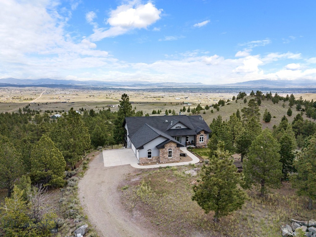 Experience elevated mountain living in this highly coveted Northwest Helena Valley retreat. This stunning 4-bedroom ranch-style home offers seamless main-level living, a fully finished walk-out basement, and breathtaking panoramic views of the valley, Lake Helena, and the Big Belt Mountains. Flooded with natural light, the layout is expertly designed to capture the landscape, featuring two distinct upper decks perfect for morning coffee, entertaining, or unwinding right outside the primary suite.

Inside, the home balances luxury and comfort with a cozy gas fireplace, central A/C, under cabinet lighting, and a dedicated reverse osmosis water system. The lower level is an entertainer’s dream, boasting a bonus office space ideal for remote work, a high-efficiency catalytic wood fireplace, and a full theater room. Premium surround sound systems provide immersive audio across both levels.

Step out onto the walk-out basement patio to enjoy frequent visits from local deer, or tend to your fully fenced garden boxes and flower beds, all kept lush by underground sprinklers and a dedicated drip irrigation system. True peace of mind is built right in a heated three-car garage and a 50-amp generator hookup wired directly for emergency home loads. Designed for modern connectivity, the property is smart-home ready with Z-wave technology—including automated locks, climate control, and safety sensors—and comes pre-wired for both a security system and Starlink.