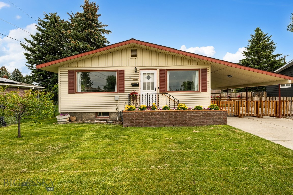 Bright, cheerful and full of personality, this beautifully maintained Parkview Court home is ready for its next chapter. Colorful lily perennials bloom yearly in the front brick planter box, creating inviting curb appeal, while off-street parking and a covered 405-square-foot carport provide everyday convenience and a perfect spot for backyard gatherings.

Inside, sunlight pours through the large living and dining room windows, highlighting the built-in shelving and welcoming spaces throughout the main level. The charming, country-chic kitchen features newer appliances and opens to a cozy dining nook with a built-in bench that's sure to become everyone's favorite seat in the house. The 3 bedrooms and full bathroom complete the main floor.

Downstairs offers even more room to spread out with a spacious family room centered around a wood stove, along with abundant storage. With an additional non-conforming bedroom, office space, 3/4 bathroom and built-in storage everywhere you look, this 2,378 sqft home is waiting for someone to finish making it their own. A gas forced-air furnace, air conditioning and a water softener add comfort and convenience.

Outside you can enjoy a backyard that's as productive as it is fun. Raised garden beds, a greenhouse and a small chicken coop make fresh eggs and homegrown vegetables part of everyday life, while underground sprinklers help keep everything looking its best. The attached carport creates an ideal space for outdoor entertaining or parking, and the storage shed conveys for even more room to keep tools, toys and gardening supplies organized. The front fence is movable to easily set it up however you wish.

Conveniently located near schools and Vigilante Field, this home offers the perfect blend of fun, flexibility and opportunities to gather, garden, entertain and make lasting memories.