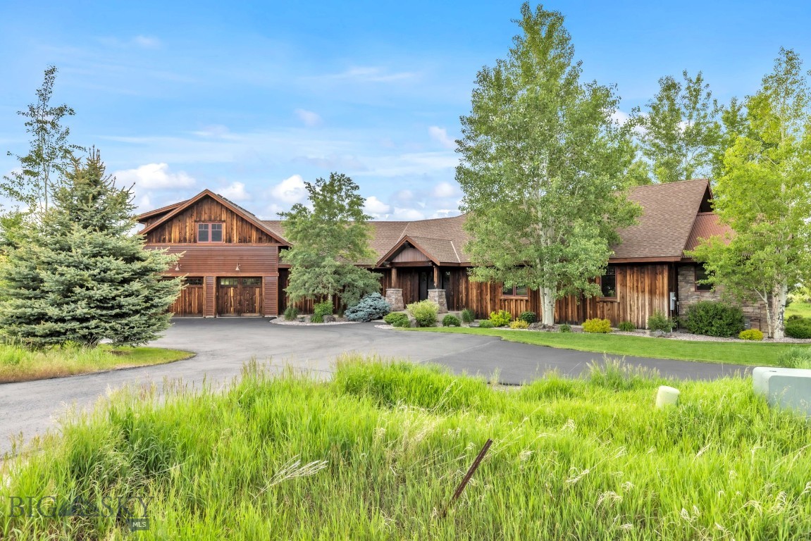 This is it - the one you've been waiting for! Jaw dropping views in every direction, NO HOA, and NO Covenants. Less than 10 minutes from town, this gorgeous custom home sits on 4.25 acres. Could it get any better? Freedom to bring your horses, build a barn, or come up with your own idea for this idyllic setting. The entire perimeter has an electric dog fence, so your furry pals will love having the ability to roam here as well! Lives like a single level with ample space for visiting in-laws upstairs. Soaring 22 foot ceilings and stacked stone fireplace offer a cozy, yet understated luxury feel and the Bridger Views shine through the windows surrounding the fireplce. Thoughtful floorplan works perfectly with the primary separated from the secondary bedrooms creating privacy for those who aren't night owls. Circle sawn hardwoods and custom trim work give it that solid, quality feel throughout. Bedrooms are spacious with nice sized closets. Primary closet is a dream come true with custom built-ins galore! Large office features big southern views and a custom built-in Murphy bed for those times when you need more sleeping space. Kitchen features a perfect triangle and the layout is a dream for entertaining. Cute coffee bar/butler's pantry can be tucked away behind a barn door so your daily clutter doesn't reside on your countertops. Current owners upgraded the forced air system to include AC, dual stage heat, and Trane Clean Effects UV and Ionizer air scrubber/purifier. Out back, you'll find an RV/Utility parking pad behind the garage wired for 220v.
Spaeking of the garage, it's oversized and makes projects easy in the winter or summer months, not to mention plenty of storage for all your gear. The raised bed garden has been thoughtfully installed and has produced boundless crops of herbs, veggies, and flowers over the years. Conveniently, there is a garden shed nearby to house all the accessories needed to tend to both the garden and the yard. Simply put, this one has it all - you are going to love it!