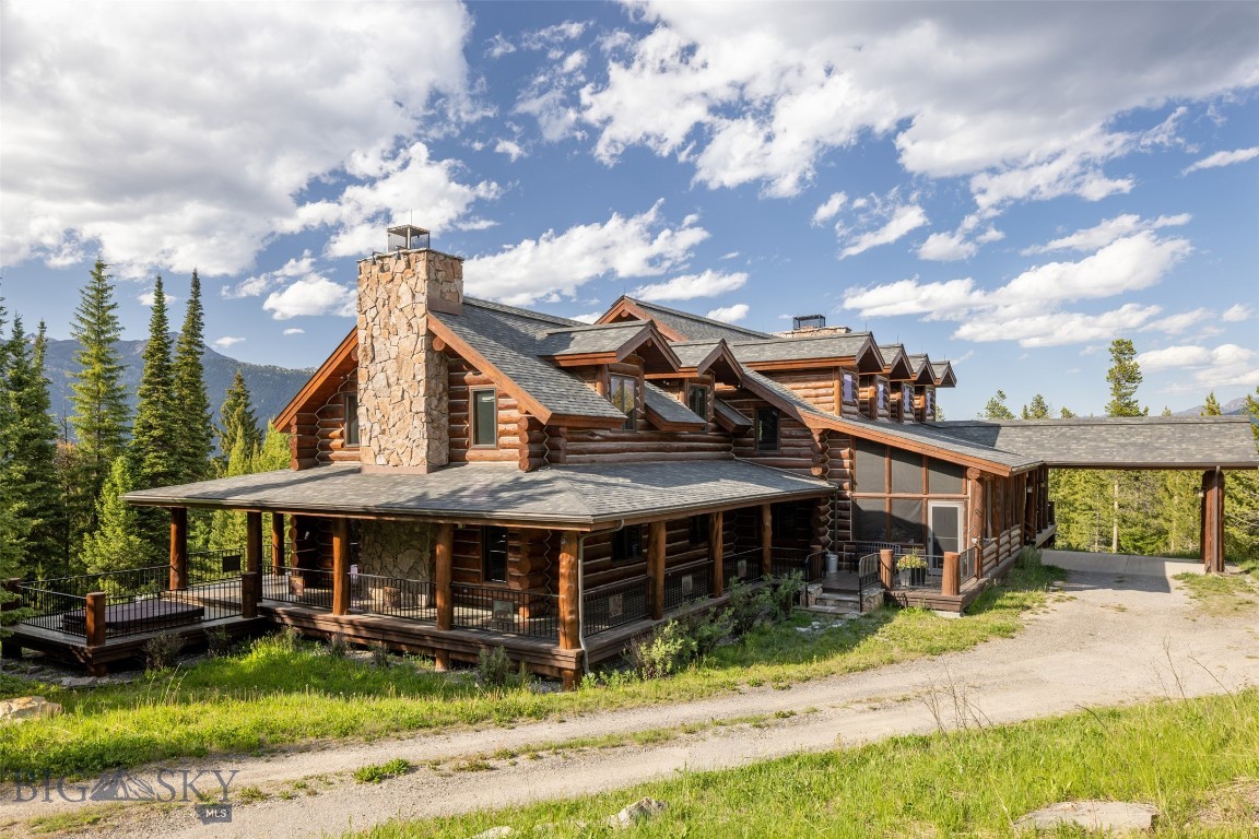 A home built for gathering, a property built for living Montana fully.Welcome to Montana Legacy Lodge, an extraordinary mountain retreat set on a rare 40-acre double lot in the coveted Elk Ridge Ranch community of Big Sky. Offering 5 bedrooms,6 bathrooms,and 5,451 square feet of thoughtfully designed living space, this remarkable luxury log home comfortably sleeps 14 guests, making it the perfect setting for family gatherings, corporate retreats, and unforgettable Montana adventures.Perfectly positioned just 15 minutes from Big Sky Town Center and only minutes from the iconic Gallatin River,the property enjoys breathtaking, unobstructed views of Lone Mountain and the Spanish Peaks, creating a spectacular backdrop in every season.Built in 1999 and professionally maintained, this classic Big Sky lodge blends timeless craftsmanship with the rugged elegance of mountain living. The home's centerpiece is a massive timber-frame great room with soaring vaulted ceilings, extraordinary character, and a dramatic floor-to-ceiling stone fireplace. Expansive windows frame the surrounding mountains and meadows, bringing Montana's natural beauty into every corner of the home.The gourmet chef's kitchen is equipped with premium appliances, generous prep space, and seamless access to both indoor and outdoor entertaining areas. Adjacent gathering spaces create an inviting atmosphere where friends and family can connect after a day of adventure.The spacious main-level primary suite serves as a private sanctuary, complete with its own stone fireplace and tranquil mountain views. Upstairs, you'll find two additional ensuite bedrooms and a comfortable family room, while the lower level offers another guest bedroom and bath, along with a one-of-a-kind bunkroom featuring custom built-in bunks inspired by a classic train car.Outdoor living is equally exceptional. An expansive 360-degree wraparound deck provides endless opportunities for entertaining, wildlife viewing, and soaking in Montana's breathtaking scenery. For outdoor enthusiasts, the property offers a lifestyle few can match. During the summer, ride your horses directly from the property to the Roadhouse Grill for dinner & live music. In the winter, snowmobile with your kids to school. Hike or Mountain bike from the Uplands Trail down to Big Sky’s Town Center. The property also includes a dedicated workshop ideal for fly tying and custom rod building.