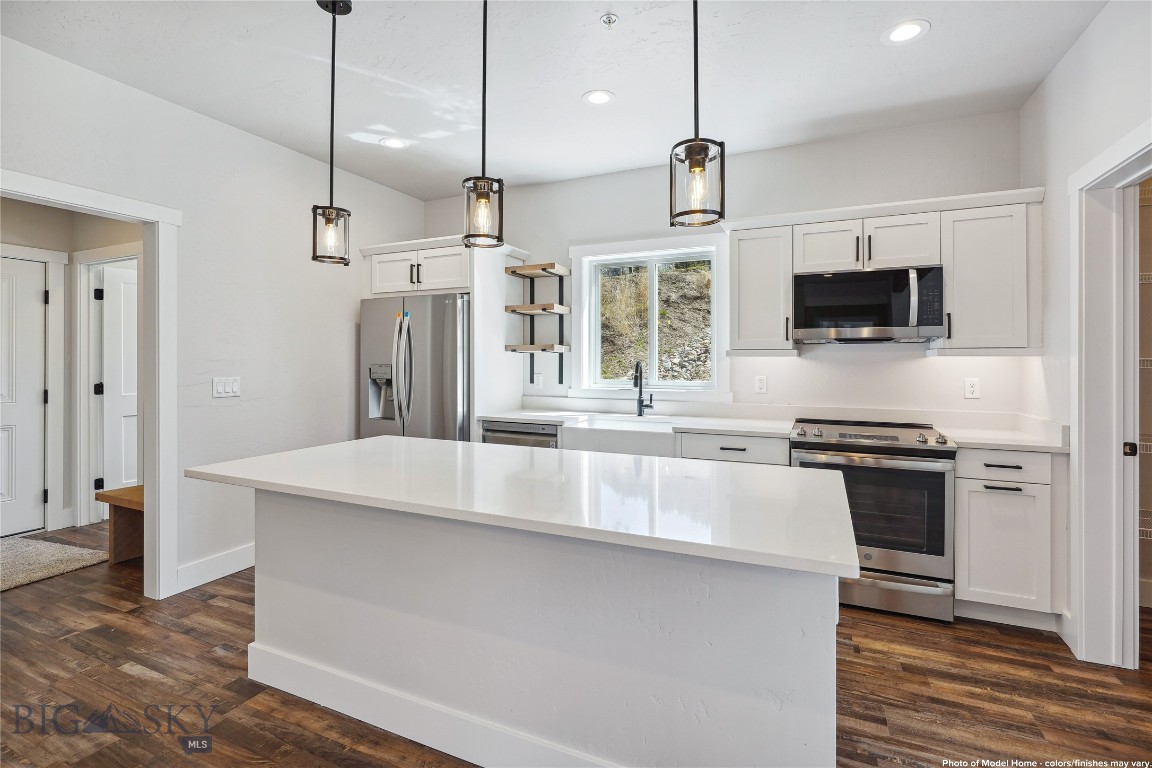 Set in a peaceful spot surrounded by trees with beautiful mountain views, this unit offers a quiet, scenic setting that feels distinctly Montana. Less than 10 minutes from Helena and located in the welcoming town of Montana City, this new construction condo sits in a 55+ community where nature and convenience meet. The 1,752 sqft layout offers main-floor living with 2 bedrooms, 2.5 bathrooms, quartz countertops, and a smart, open floor plan. Wide hallways, grab bars, and a zero-entry shower in the primary suite make it accessible and easy to navigate. Built with your health in mind, the home includes a whole-house water filtration system and a heat recovery ventilator that helps remove allergens like pollen and smog. Outside, explore private walking trails, relax by the pond, follow the banks of Prickly Pear Creek, or catch up with neighbors at the clubhouse. Thoughtful covenants help maintain the peaceful setting, and you can even tailor the finishes to match your style. Schedule a showing today!
Home is currently under construction - all interior photos are of the Model Home, not of this unit. Final Colors/Finishes/Upgrades may vary.