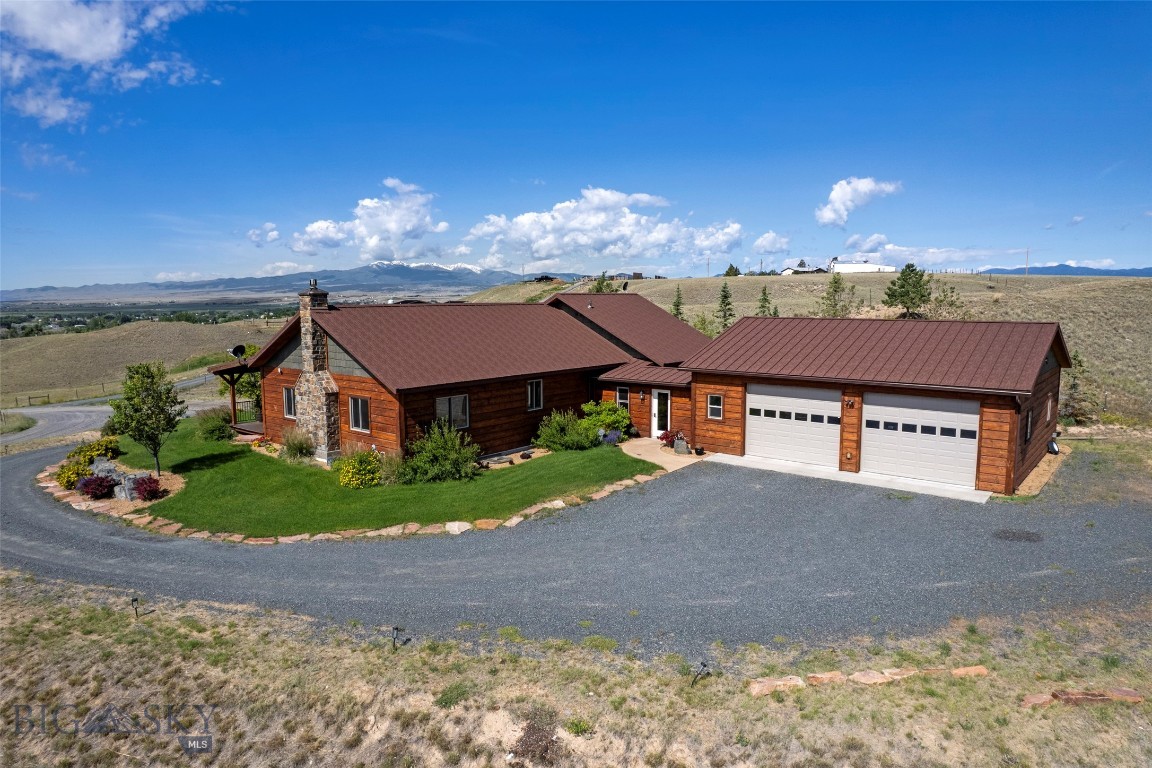 Set on just under 7.5 acres of beautiful, serene landscape, this 3,938 sq ft custom-built home offers the perfect blend of craftsmanship and comfort. Durable wood siding, refinished two summers ago, wraps the exterior in lasting curb appeal, while the interior delivers timeless charm with all the comforts of modern living.
Inside, enjoy beautiful hardwood, tile, and carpeted flooring on the main level, plus a gorgeous kitchen with rich wood cabinetry. The upstairs is an entertainer's dream, with high ceilings and added windows that fill the main living area with natural light. Cozy up by the gas fireplace, or enjoy the comfort of central air conditioning. There's generous space to gather, plus a large front deck built with low-maintenance Trex decking, accessible from both the master bedroom and the main living area. Take in relaxing views across the Jefferson Valley, the Jefferson River, and the Tobacco Root Mountain Range.
The walkout basement adds even more versatility, with its own full kitchen, spacious party/entertaining area, one full bathroom, one bedroom, and a media room. The dining area opens out to a beautiful stamped concrete patio. Durable Hardie plank vinyl flooring runs throughout, and this level could easily be separated with an added door to create an independent dwelling unit — ideal for rental income or multigenerational living.
Outside, custom high-end landscaping sets this property apart, featuring decorative concrete, large accent rocks, mature trees, and a sprinkler system. With plenty of open room to roam, the property is well-suited for horses which covenants allow!The oversized two-car garage comes equipped with a backup generator for added peace of mind.
Without homes closely surrounding you, this property offers plenty of space and an out-of-town feel, all while staying just a short drive from town for groceries and everyday conveniences. You're just 20 minutes from Butte, Montana, and less than an hour from Bozeman, Montana.
Thoughtfully designed with accessibility in mind, the home includes handicap-accessible bathrooms.
With incredible space for entertaining both upstairs and down, plus beautiful, relaxing views, this is a rare opportunity you won't want to miss.