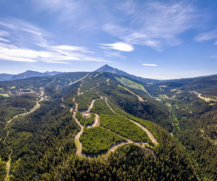 Discover Powdercrest, the final land release for custom-built homes within Spanish Peaks Mountain Club. This remarkable new neighborhood introduces 31 exceptional homesites—an exclusive opportunity to own among the last true ski-in, ski-out properties in one of Big Sky’s premier, members-only communities.

Spanning the slopes of Flatiron Mountain, these generously sized parcels offer a rare balance of privacy, expansive views, and future direct lift access via a planned chairlift. Owners will step seamlessly onto the slopes of Big Sky Resort while enjoying a sense of space and seclusion seldom found in world-class alpine destinations.

Positioned along a dramatic ridgeline with unobstructed mountain panoramas, each homesite is thoughtfully sited to capture abundant natural light, jaw-dropping views, close trail access, and year-round outdoor living. Ownership includes access to an exceptional collection of current and future amenities, including dining, two Weiskopf-designed golf courses, the Spanish Peaks Clubhouse, Montage Big Sky, the highly anticipated Member Lodge Aspire, and an expanding ski network, all contributing to an already unmatched mountain lifestyle. Combined with close proximity to Big Sky’s vibrant Town Center and the untamed wilderness of Yellowstone National Park, this is truly an opportunity not to be missed.

Owners may choose between Social or Signature Golf membership at Spanish Peaks Mountain Club, joining an outdoor-focused community of like-minded mountain enthusiasts from around the world. To further streamline the path to ownership, buyers may also take advantage of the highly regarded Design Build Program.

This represents the final opportunity to create a custom legacy residence at the heart of Spanish Peaks—where world-class recreation, protected open space, and authentic alpine character define one of the most coveted addresses in Big Sky, Montana.

Lot 7 is 6.68 acres with primo ski-in, ski-out, and offers expansive views looking toward the Gallatin and Madison Ranges.