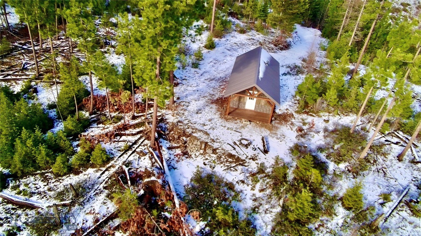 There are places in Montana that still feel untouched—where the land stretches wide, the air carries the scent of pine, and the horizon seems to go on forever. This 935± acre holding in Sanders County is one of those rare places. Rolling forested hills give way to open clearings and expansive viewpoints. Towering trees provide privacy, shelter, and wildlife habitat, while the varied terrain invites exploration in every season—whether on foot, horseback, or by trail. Tucked quietly within the landscape is a rustic dry cabin, warmed by a woodstove and designed as a true backcountry refuge. It’s a place to return after a long day of hiking ridgelines, tracking game, or simply watching the light change across the mountains. Evenings are spent under a canopy of stars, with only the sounds of nature breaking the silence. This property is a haven for outdoor enthusiasts. The acreage supports exceptional hunting opportunities, along with endless room to roam, ride, and explore. From early-morning sunrises over the timber to crisp fall days and snow-covered winters, the land offers year-round adventure and solitude. With legal access, no covenants, and vast acreage to shape your own vision, this is more than just land—it’s an opportunity to own a true Montana retreat. A place to unplug, reconnect, and create a legacy rooted in freedom, wilderness, and wide-open space.