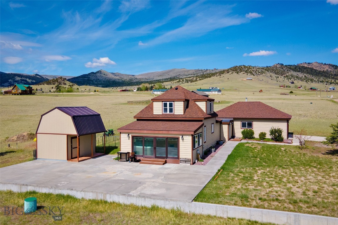 Montana living on 5.107± acres just outside of Ennis. This remodeled 3-bedroom, 1.5-bath home offers mountain views, usable acreage, and a peaceful rural setting with no HOA and light covenants. Features include a bright sunroom with Pella windows and doors, handcrafted wood details, updated appliances, wood and gas stoves, flexible bonus living space, and an 8-person saltwater hot tub room. Additional improvements include a new roof in 2024, storage shed, and additions completed in 2019. Conveniently located just minutes from Ennis while offering privacy and room to spread out.