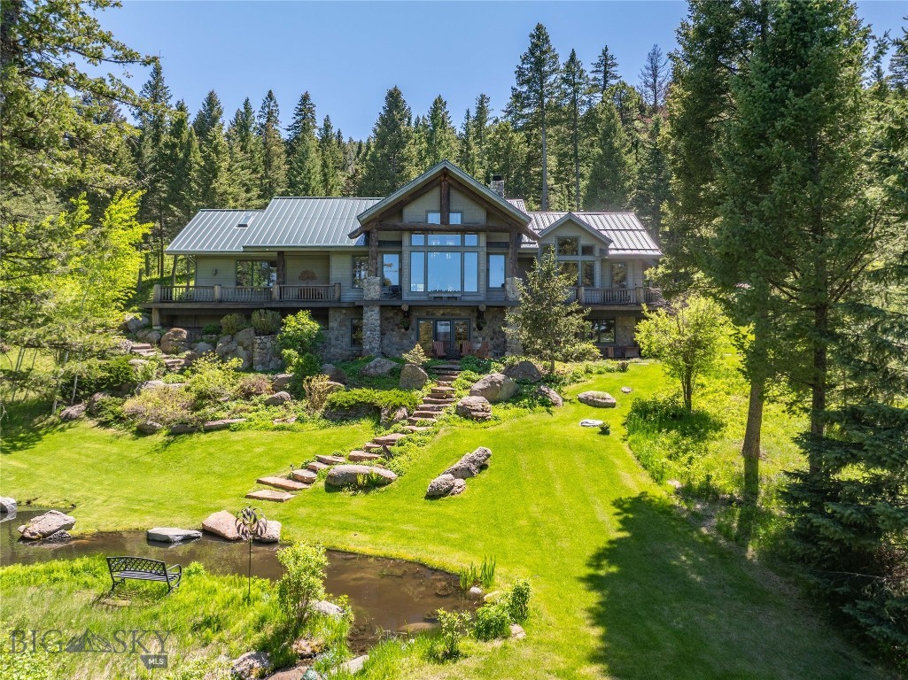 Welcome to one of the most special properties in Eagle Rock Reserve. One of only six alpine lots in the community, this 20-acre retreat is tucked among towering evergreens, wildflowers, and two tranquil ponds with cascading water features, creating a private, park-like setting just 15 minutes from downtown Bozeman.  Designed by renowned architect Faure Halvorsen and built by respected Bozeman craftsman Jim Syth, the 4,516 SF custom home blends mountain architecture with warmth and livability. Expansive windows frame Bridger Mountain views, while the rest of the home sits quietly within a canopy of mature forest, offering a true Montana retreat.  Inside, vaulted ceilings, rich wood detailing, and a dramatic floor-to-ceiling stone fireplace anchor the great room. The thoughtful layout includes a main-level primary suite, a walk-out lower level with guest bedrooms and family room, and a light-filled loft with office or studio spaces, ideal for creative work or remote living.  Outdoor living is equally special, with a wraparound deck, covered patio, and peaceful seating areas woven into the landscape.  Residents of Eagle Rock Reserve enjoy access to a private equestrian facility, stocked trout pond, maintained trails, and adjacent State Land, with nearby access to Triple Tree Trail and National Forest.  A rare alpine sanctuary where privacy, craftsmanship, and the Montana landscape come together, just minutes from Bozeman.