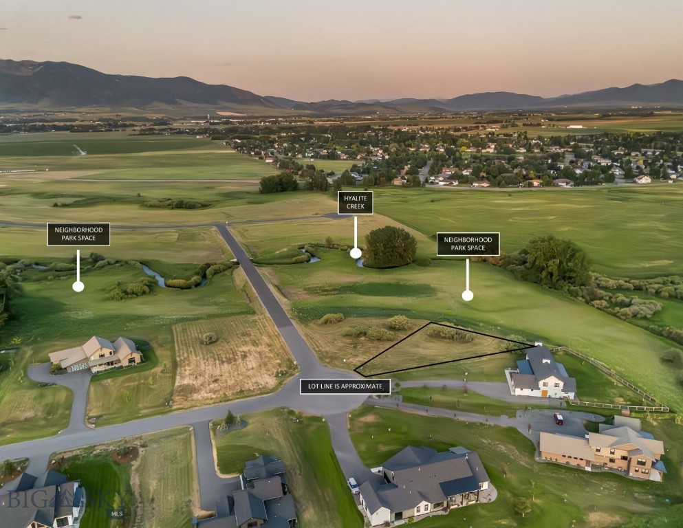 BEST VALUE AVAILABLE IN RIVERWOOD SUBDIVISION! Discover the perfect canvas for your Montana dream home in Riverwood South subdivision. This prime lot offers rare privacy and southern exposure, nestled beside designated open space and a meandering creek—ideal for quiet mornings, evening walks, and immersive natural views. Positioned for convenience and connection, you’re just minutes from Belgrade, Bozeman, and Yellowstone International Airport, making this location as practical as it is scenic. Wake up to breathtaking views of both the Gallatin and Bridger Mountain ranges, with the ever-changing skies framing your 360-degree views. Surrounded by well-designed custom homes in a vibrant neighborhood, this lot combines community warmth with individual character. Whether you're ready to build now or planning for the future, this property offers an unmatched balance of natural beauty, accessibility, and long-term value.