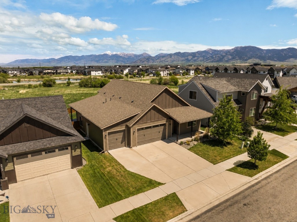 Set against a backdrop of breathtaking Bridger Mountain views and incredible open space behind the home, this beautifully maintained single level property offers the perfect balance of comfort, privacy, and functionality. Two bedrooms are situated at the front of the home and share a full bathroom, offering a functional layout for guests or family. As you move into the heart of the home, soaring ceilings and a cozy fireplace create a warm and inviting atmosphere in the spacious living room. The open concept kitchen is ideal for entertaining, featuring granite countertops throughout, a gas range, tile backsplash, abundant cabinetry and storage, a large walk in pantry, and seamless flow into the dining and living spaces. Just off the dining area, an additional flex room has been used as a home gym and would also make an excellent office, creative space, or playroom, complete with direct access to the patio. Privately positioned on the opposite side of the living room, the primary suite is filled with natural light and designed for relaxation, featuring dual vanities, a beautiful tiled shower and soaking tub, and a spacious walk in closet. Central A/C, a spacious laundry room, convenient mudroom, and oversized 3 car garage add thoughtful practicality throughout. Enjoy morning coffee or evening sunsets from the patio while taking in the unobstructed mountain views and peaceful open space setting. Westbrook’s parks and trails are thoughtfully woven throughout the subdivision with multiple paths and green spaces nearby, while Gallatin County Regional Park is just minutes away and offers ponds, trails, sledding hills in the winter, playgrounds, open space, and a dog park. This home offers an exceptional combination of location, layout, and livability.