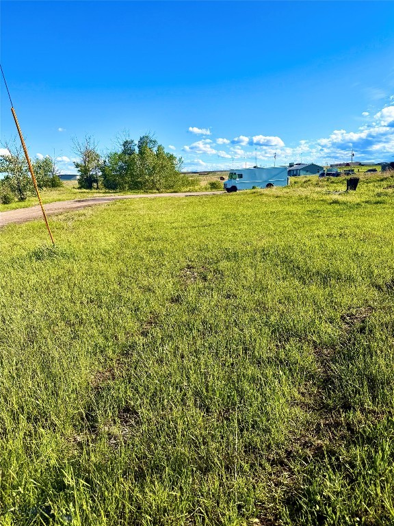On the edge of Browning, this nearly quarter-acre lot offers an affordable foothold in one of Montana's most storied landscapes. This is where the high plains roll west and break against the peaks of Glacier National Park — close enough that the mountains hold the horizon, far enough to keep life unhurried. The parcel sits on a quiet town street with legal access and water and sewer available at the road, ready for a cabin, a getaway, or a future build near the park's eastern gateway. For the price of a fresh start, Lot 1 puts you within reach of the Crown of the Continent.