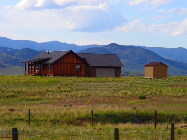 Immaculate Turn-Key Home on 20.408 Scenic Acres
This beautiful 1490+/- Sqft 3 bedroom 2 bath home offers the perfect balance of comfort, quality, and Montana charm.
The open-concept living area is warm and inviting, featuring a cozy gas stove, ideal for relaxing evenings. The kitchen is thoughtfully designed with rich hickory cabinetry, granite countertops, and a convenient eating bar, perfect for both everyday living and entertaining.
Step outside to take in the sweeping mountain views from the covered deck, where you can enjoy quiet mornings and breathtaking sunsets. This 20.408 acre parcel provides ample space, privacy, and room to enjoy the outdoors, with abundant wildlife and wide-open skies. Bring your 4-wheelers and enjoy easy access to many nearby trails that are great for hiking as well.
Additional features include a oversized attached 2 car garage, concrete apron and courtyard, perfect for enjoying a cup of coffee, well-kept grounds, and move-in ready condition. This property is a true turnkey opportunity. Whether you're looking for a full-time residence or a Montana retreat, this home is a must-see.