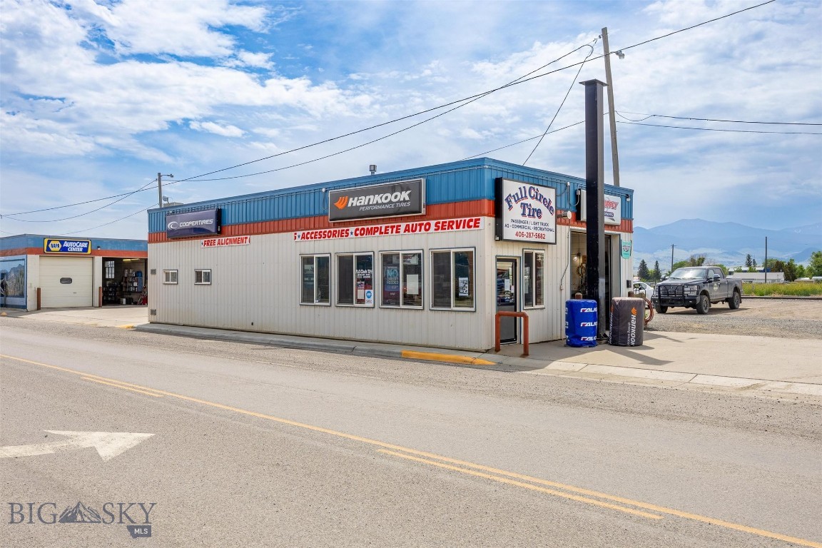 Established Whitehall Staple – High-Traffic Commercial Opportunity!  Own a cornerstone of the Whitehall community with Full Circle Tire, a premier turnkey tire shop and oil changing business serving local ranchers, residents, and highway travelers. This high-traffic opportunity includes two specialized buildings on a 7,144 sq. ft. lot. The 1,400 sq. ft. Main Hub features a small showroom, waiting area, office and work station.  Complementing this is the 2,250 sq. ft. Mechanical & Storage Facility, which includes an oil pit and work station. The operation also includes 13,580 sq. ft. of additional leased land directly south, providing vital space for oversized vehicle parking and outdoor storage. Fully equipped and strategically located, Full Circle Tire is primed for immediate and continued success.
