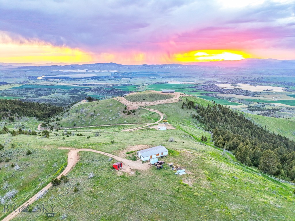 Come experience living in Big Sky Country with this off-grid retreat offering unmatched views and sustainable living! Located in the greater Three Forks area, this two-bedroom, two-bath home sits on just over 10 acres, with sweeping vistas of the Missouri River, Canyon Ferry Lake, and surrounding mountain ranges! Inside, you'll find beautiful and durable laminate flooring, a stainless steel kitchen - and a toasty wood-stove fireplace! - But here's the real good stuff - this energy-efficient home is powered by a 2,500 kW solar system and features a 14,000-gallon rainwater collection cistern and an on-demand water heater, allowing you to enjoy all the modern amenities while living independently! The open floor plan, vaulted ceilings and picture windows bring the outside in, framing the beauty of the landscape from every room! You’ll stay connected with reliable cell service and Wi-Fi, and a snow plow truck conveys to help maintain year-round access. Whether you're seeking a weekend retreat or a full-time off-grid lifestyle, this property delivers peace, privacy and true Montana living! Schedule your showing today!