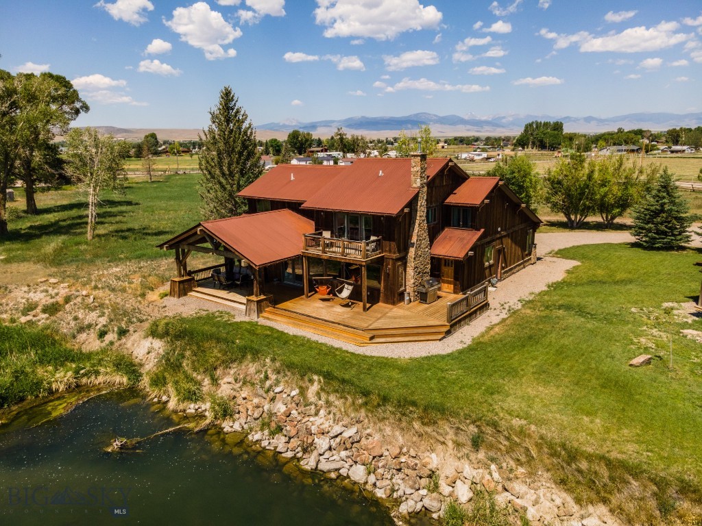 At the crossroads of where Yellowstone meets A River Runs Through It, this is an extremely rare piece of Montana beauty located on the Beaverhead River. A private boat launch, the ability to cast your favorite fly off the deck, and within minutes of every amenity one could desire in Dillon, make this a unique once in a lifetime property. Three airports are within a short two hour drive. Complete with five bedrooms, a two bedroom guest house and situated on over 6.5 spacious acres, there is room for everyone. The stone fire place is the perfect spot to gather and will warm not only your weary bones but also your soul. The open floor plan of the main level is the perfect place to gather and share smiles and laughs alike. World class fishing, waterfowl overhead and whitetail deer grace the property. Breathtaking views of the Blacktail, Pioneer, and Tobacco Root Ranges make for awe-inspiring views. The recent addition of mature trees add to the seclusion of the property and gives it a very private and tranquil feel. Hard wood floors, tiled showers, custom cabinets and countertops add elegance with some western flair. The property is serviced by a well, natural gas and septic.