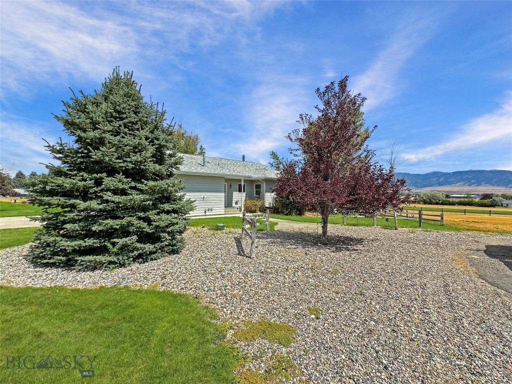 Beautiful home overlooking the second fairway of Madison Meadows Golf Course with large windows and a wrap around deck from which you can enjoy those majestic Madison Mountain views!  The house gives you the choice of 3 bedrooms - 2 baths or two living units (perfect for guests, a caretaker or a possible rental for income).  The back unit ("Apartment") is accessed through it's own private entrance via the deck or through the two car attached garage and has it's own living room (which can also be the 3rd bedroom), dedicated bedroom, bath and a small kitchenette.  The main unit accessible by either the garage or the southern porch and it has the large master ensuite unit with walk-in closet, large open living-dining-kitchen area, and laundry room.  Both units enjoy the wrap around deck as there are multiple direct accesses from the home.  The entire half acre is fully landscaped (underground sprinkler system & drip system on trees).  There is a propane fired Generac generator located in the equipment storage shed on the west side of the home.  All of this is year round accessible just minutes from downtown Ennis or head out to Madison Meadows Golf Course and play a round or two.  You can also purchase the adjoining Lot #61 MLS# 404893 for a package deal of $795,000.
