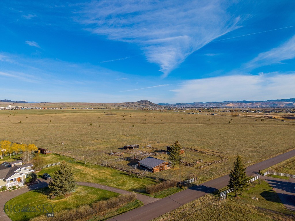 Located just outside of Butte, this 126.56± acre property presents a rare opportunity for developers, investors, and land buyers seeking scale, usability, and long-term potential in one of Southwest Montana’s growing markets. Comprised of two separate parcels totaling approximately 98.72± acres and 27.84± acres, the property offers flexibility for a variety of future ownership, development, or residential planning concepts.

With frontage along Highway 2 and Janney Road, the property benefits from excellent year-round access, visibility, and convenient proximity to Butte’s services, employment centers, schools, and recreation. The terrain is predominantly flat and highly usable, making much of the acreage well-suited for future homesites, lot layouts, infrastructure planning, or phased residential development. Large tracts with this combination of access, utility availability, and location are becoming increasingly difficult to find throughout Southwest Montana.

Natural gas and electricity are available nearby, and wells in the surrounding area have generally been drilled to reasonable depths, further supporting the property’s long-term residential potential. Continued growth in the Butte area is creating strong demand for additional housing and thoughtfully planned residential projects. The property’s size and existing two-parcel configuration may lend itself well to phased planning concepts, future lot configuration strategies, or a mix of residential offerings designed to accommodate varying buyer preferences, subject to county approval and applicable regulations.

The property is currently divided into four separate pastures with non-barbed wire fencing, adding functionality for agricultural, livestock, or equestrian use. Existing improvements include two barns, one with an attached tack room, and several structures have benefited from newer roofing improvements in recent years. These improvements may provide immediate utility for agricultural operations, horse use, or holding purposes while long-term plans are explored.

In addition to its development appeal, the property may also attract buyers seeking a large acreage homesite, equestrian property, private ranchette, or long-term land investment close to Butte. Whether viewed as a development opportunity, investment holding, or lifestyle property, this offering provides scale, accessibility, and future potential in a highly desirable location.