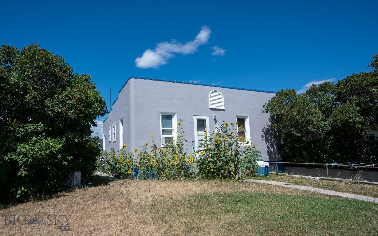Looking for a cozy, move-in-ready starter home or investment property near the university, local schools, and downtown Dillon? This 1945 home is full of vintage charm, featuring original hardwood floors and solid wood doors throughout. The basement offers a dedicated laundry area along with abundant storage and flexible space. Outside, enjoy a spacious, fully fenced backyard—ideal for kids, pets, or gardening. Mature lilac bushes surround the front of the home, providing added privacy and filling the air with their delightful fragrance each spring. Contact us today for more details or to schedule your private showing.
